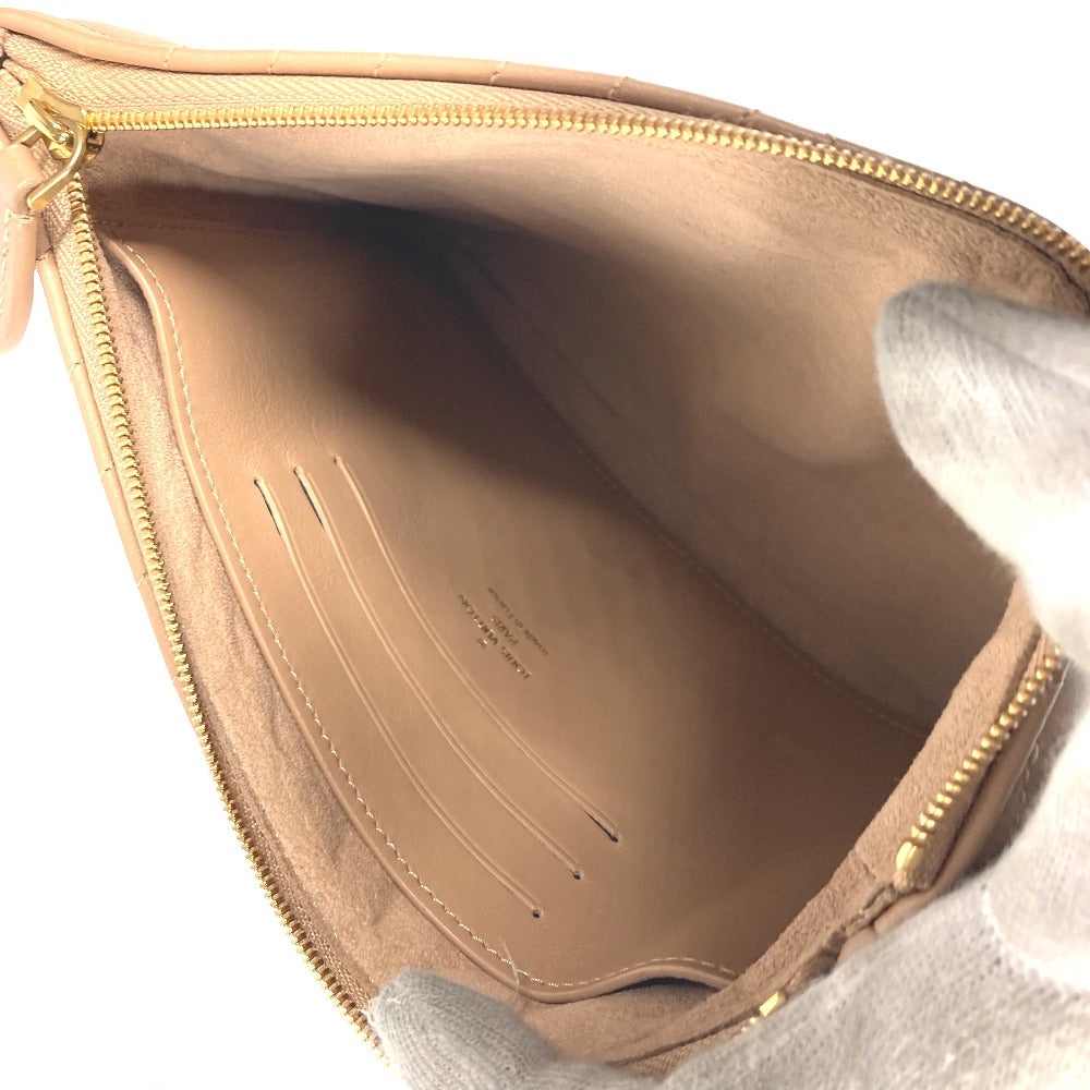 Close-up of a beige handbag interior with visible brand name.