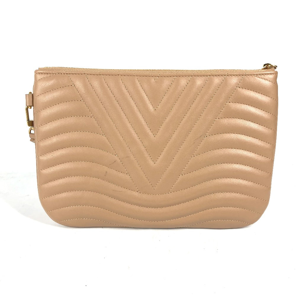Beige quilted clutch bag on a white background