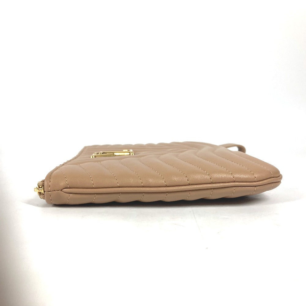 Beige quilted handbag on a white background