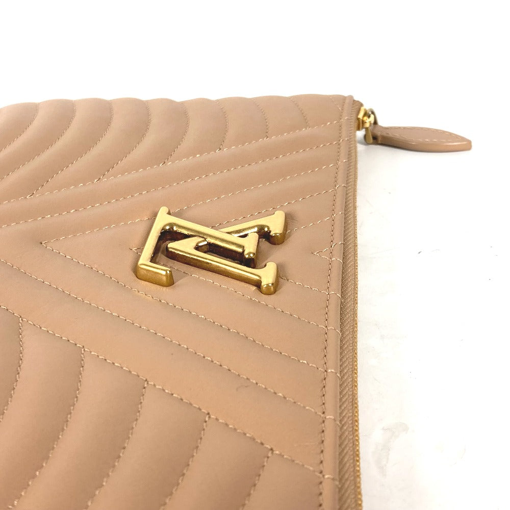 Beige quilted handbag with gold logo on a white background