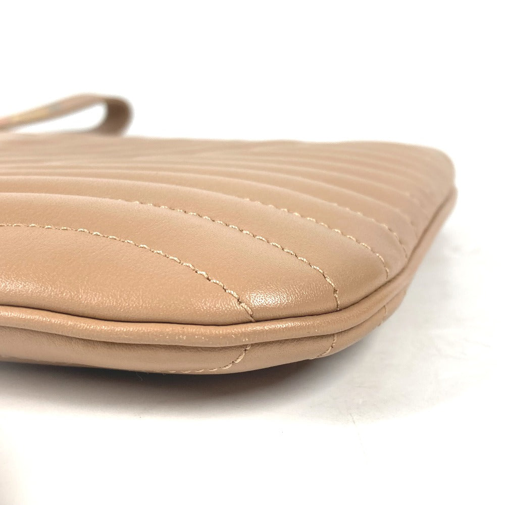 Beige quilted handbag on a white background