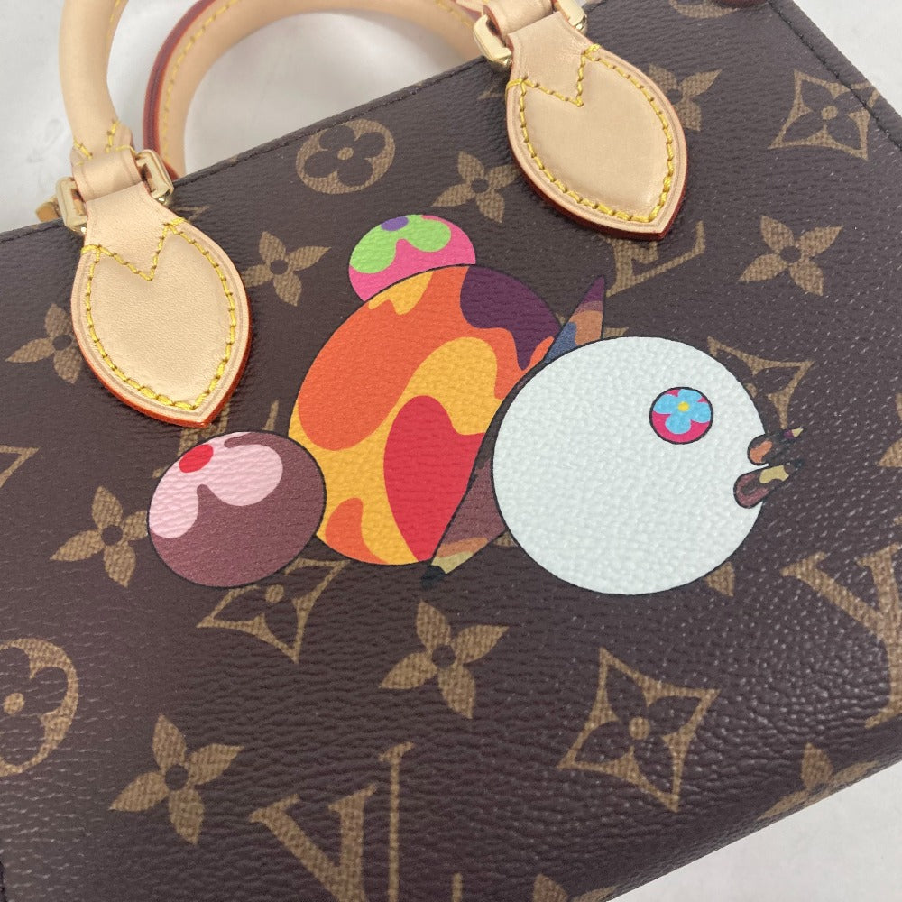 Designer handbag with colorful butterfly charm on a patterned background
