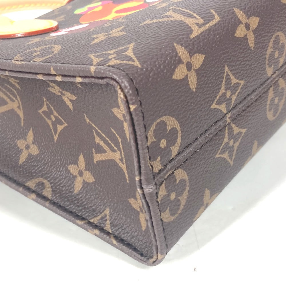 Close-up of a Louis Vuitton monogram handbag corner on a white background