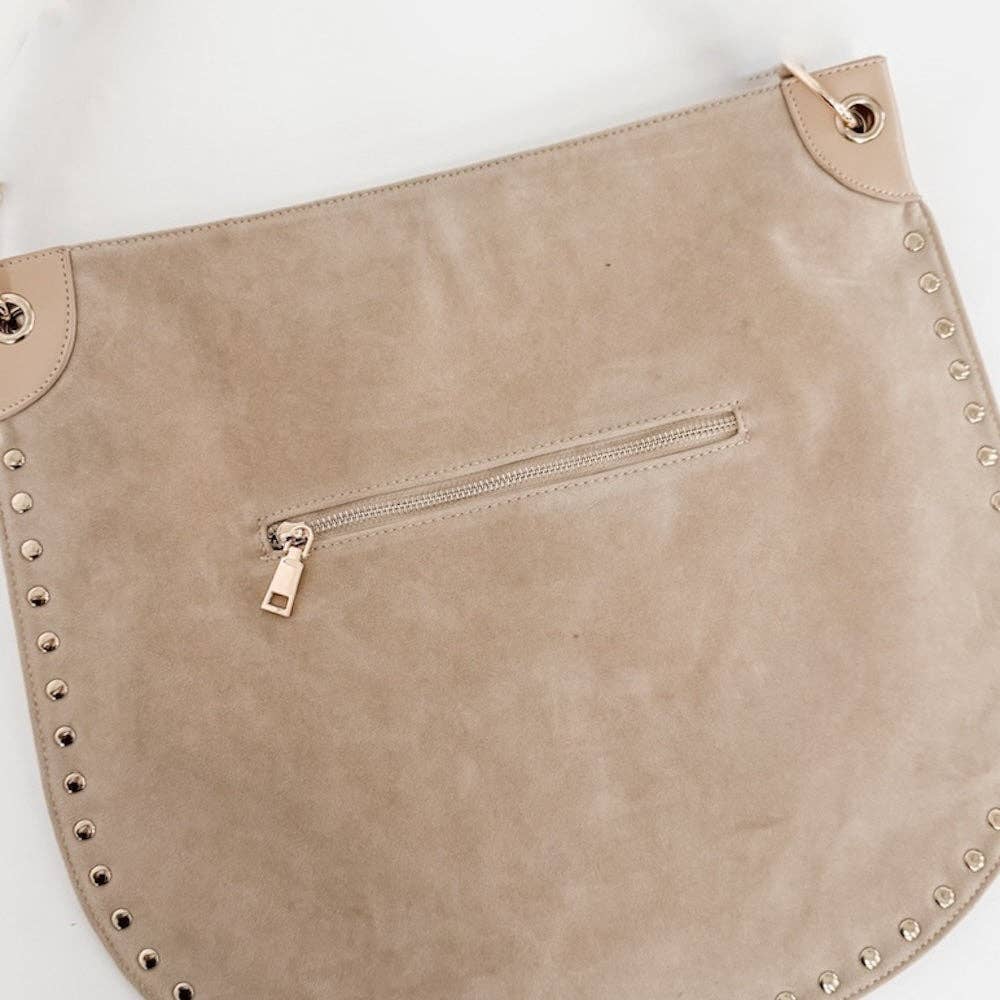 Beige clutch bag with studded details on a white background