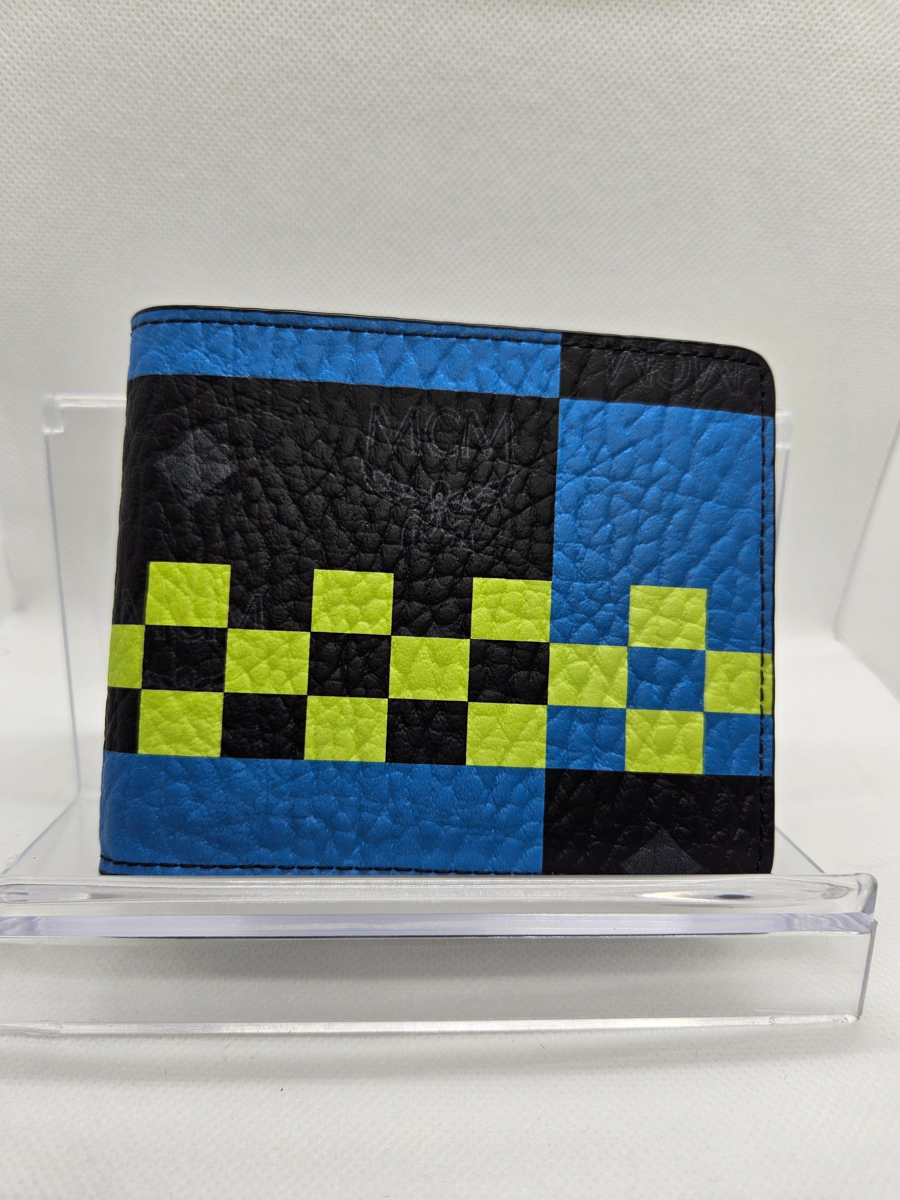 Checkered wallet with blue, black, and green pattern on a white background