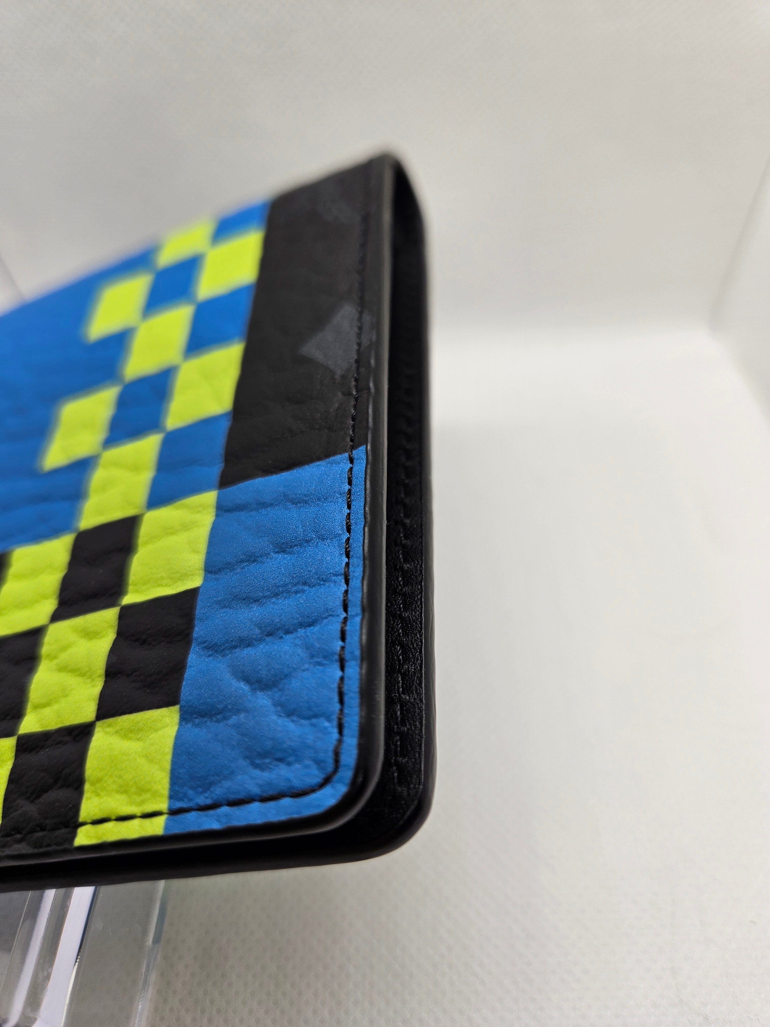 Close-up of a wallet with a checkered pattern on a white background