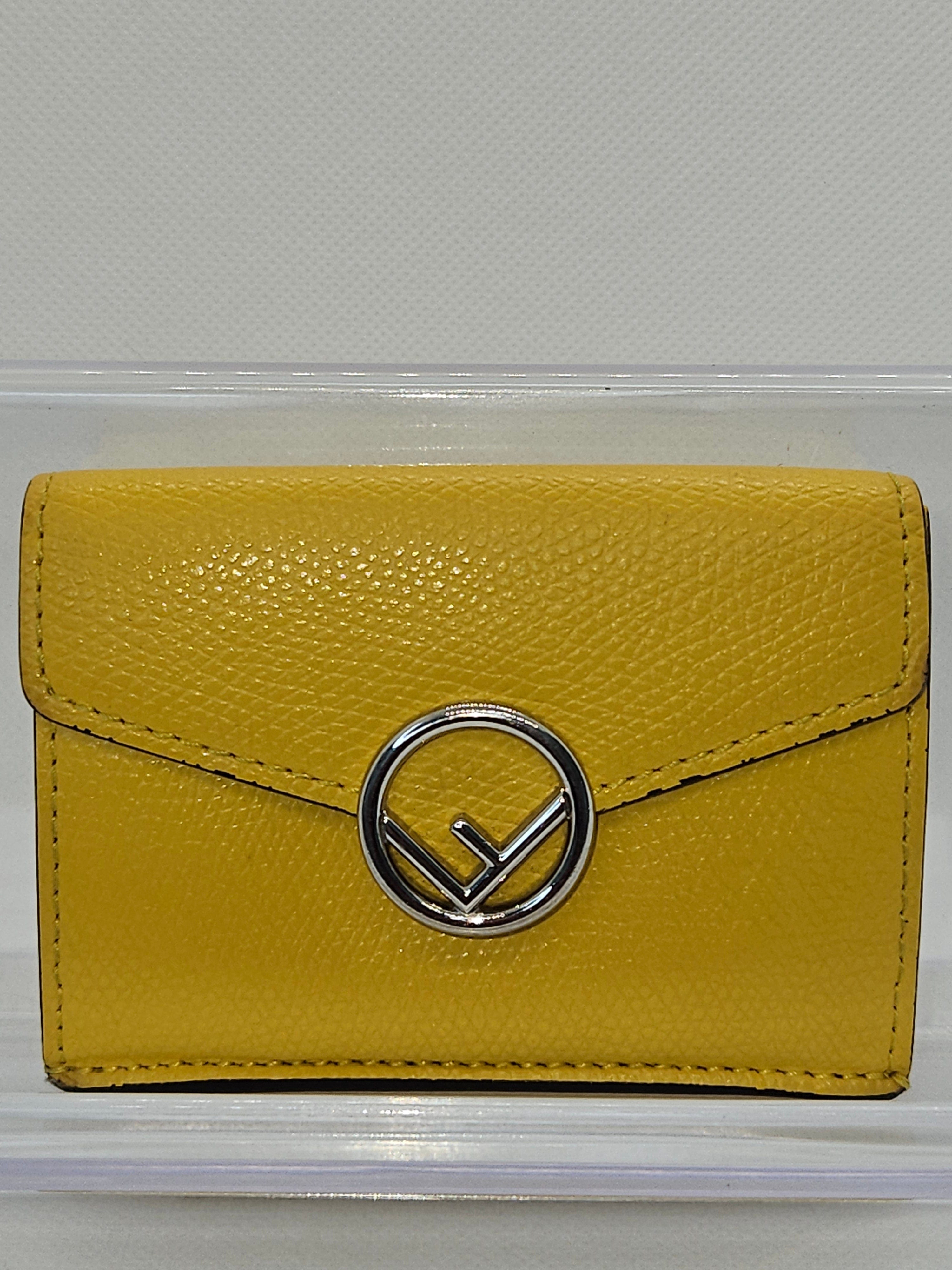 Yellow wallet with a silver logo on a white background