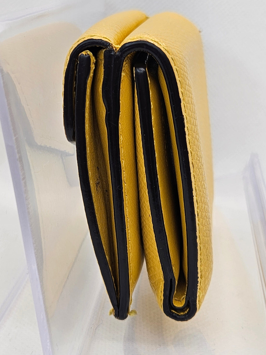 Yellow wallet with black interior on a white background