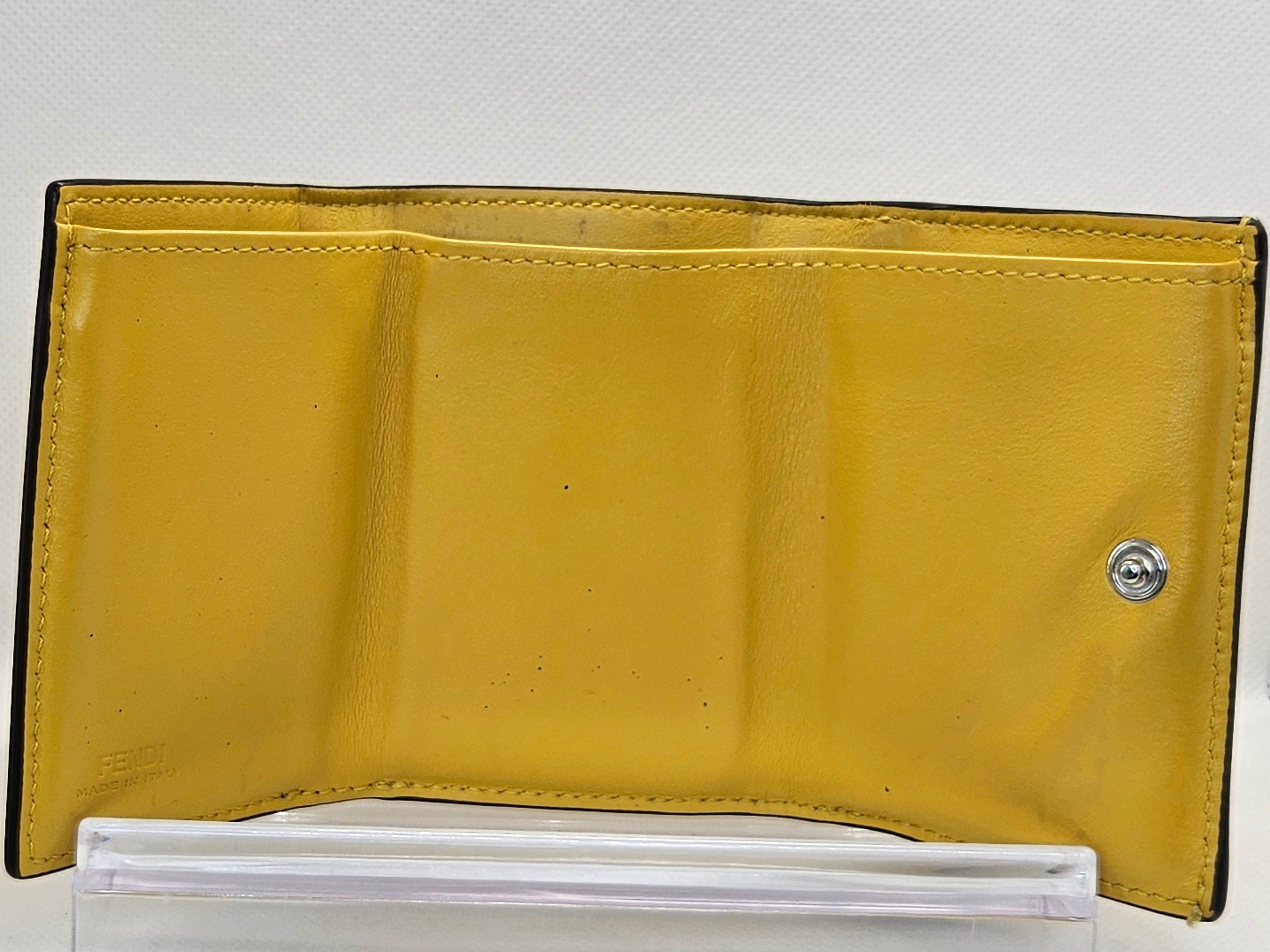 Yellow wallet with a button on a white background