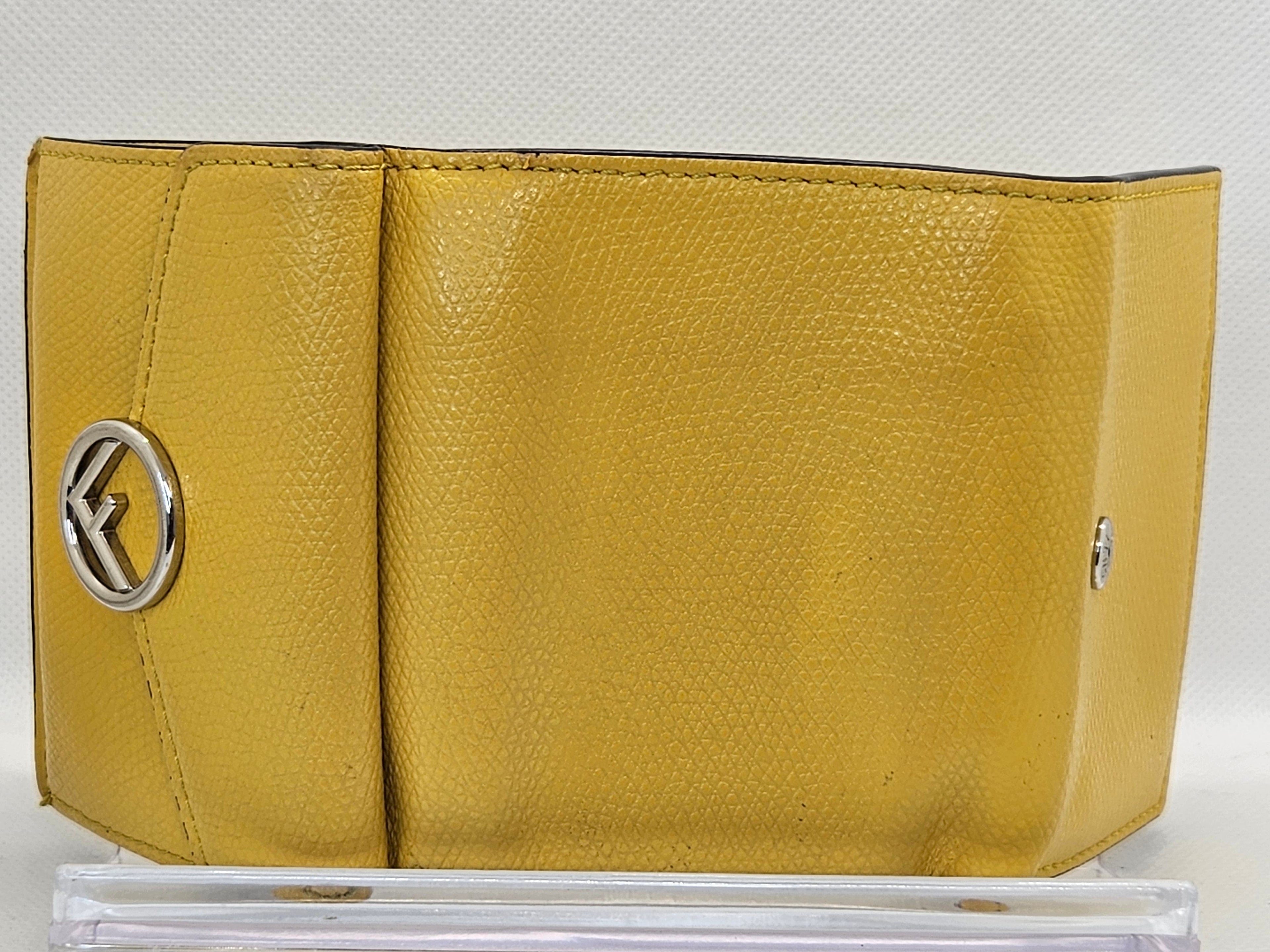 Yellow wallet with a brand logo on a white background