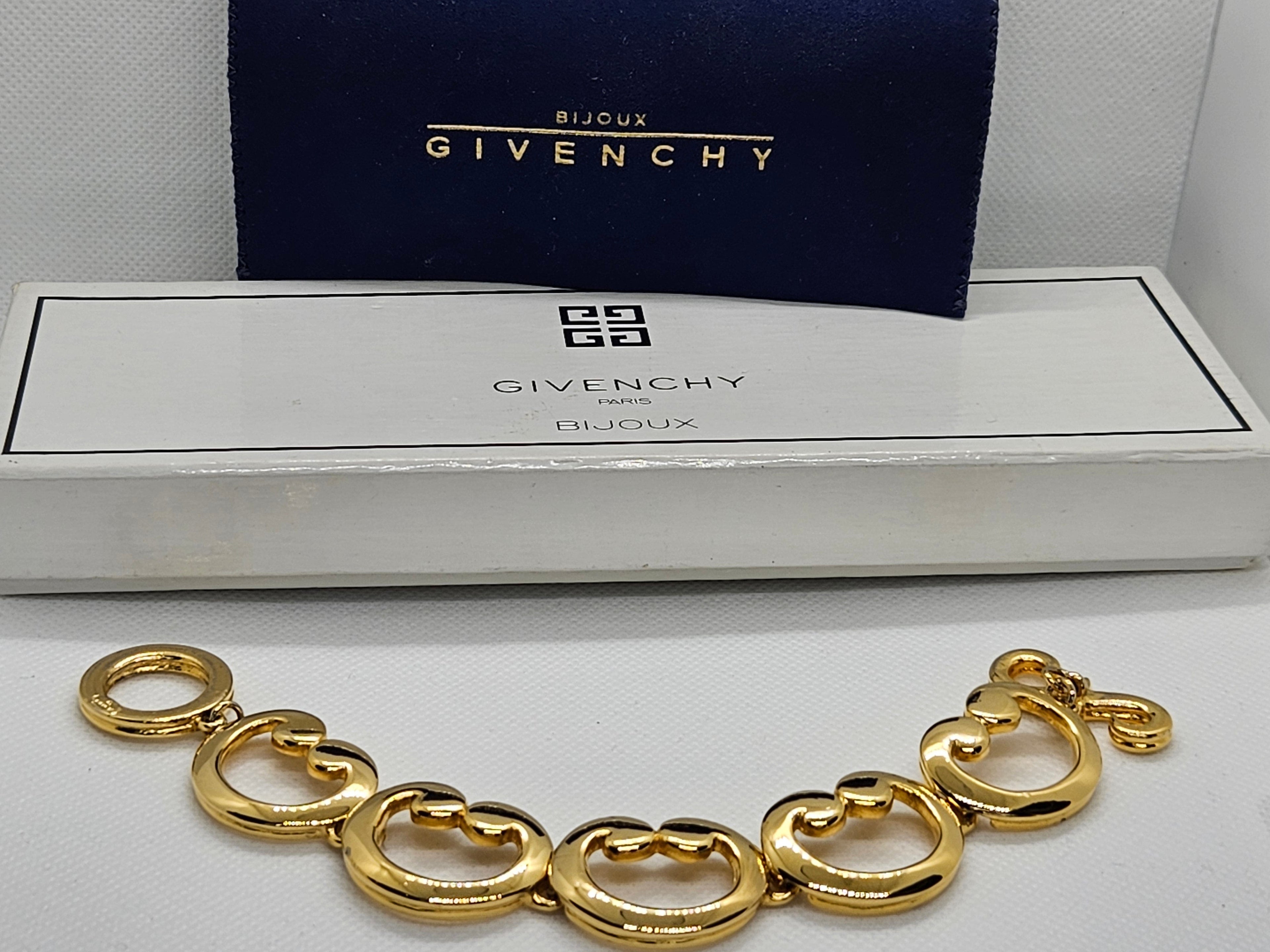 Gold bracelet in front of Givenchy jewelry box