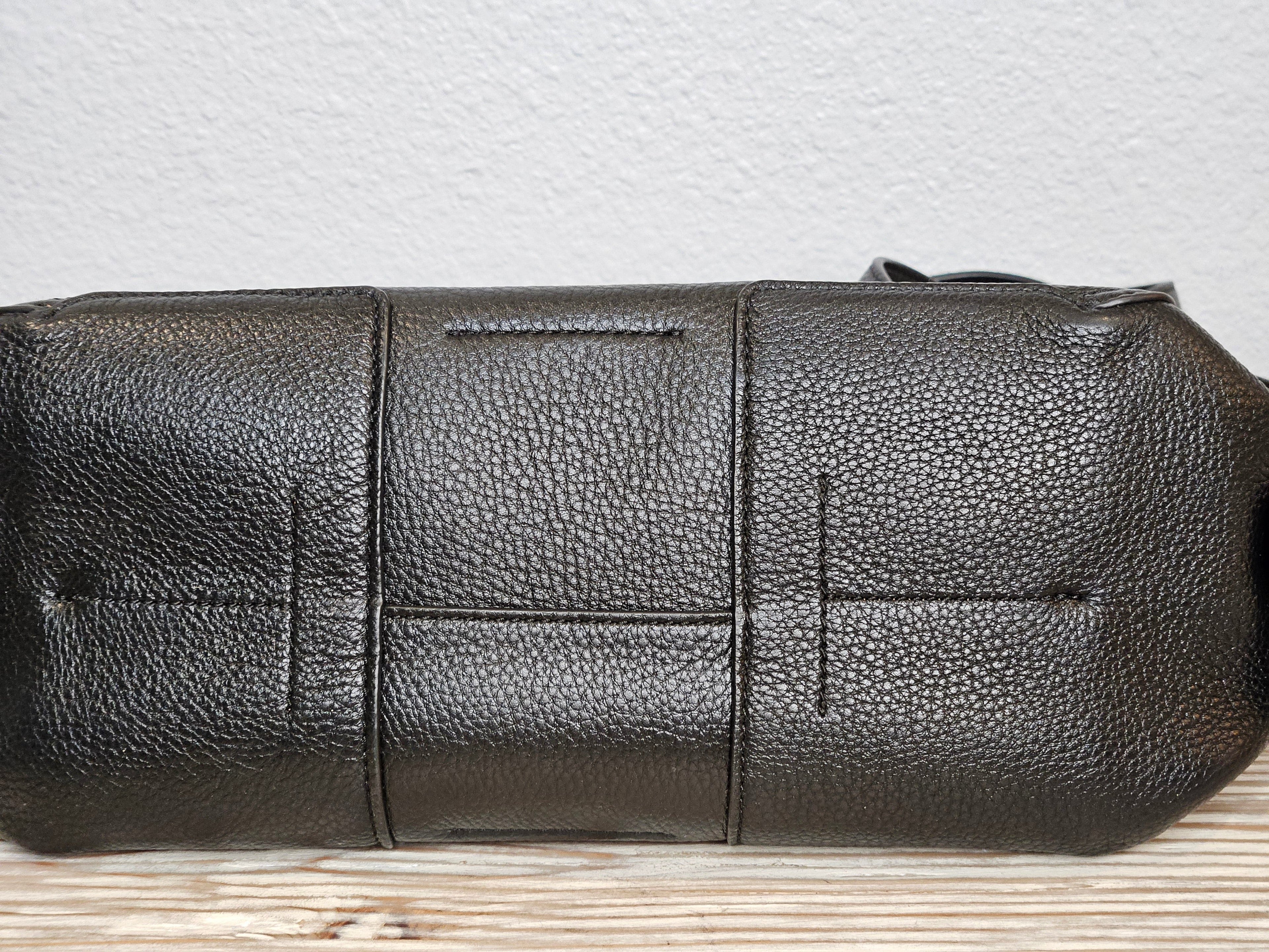 Black leather pouch on a textured surface