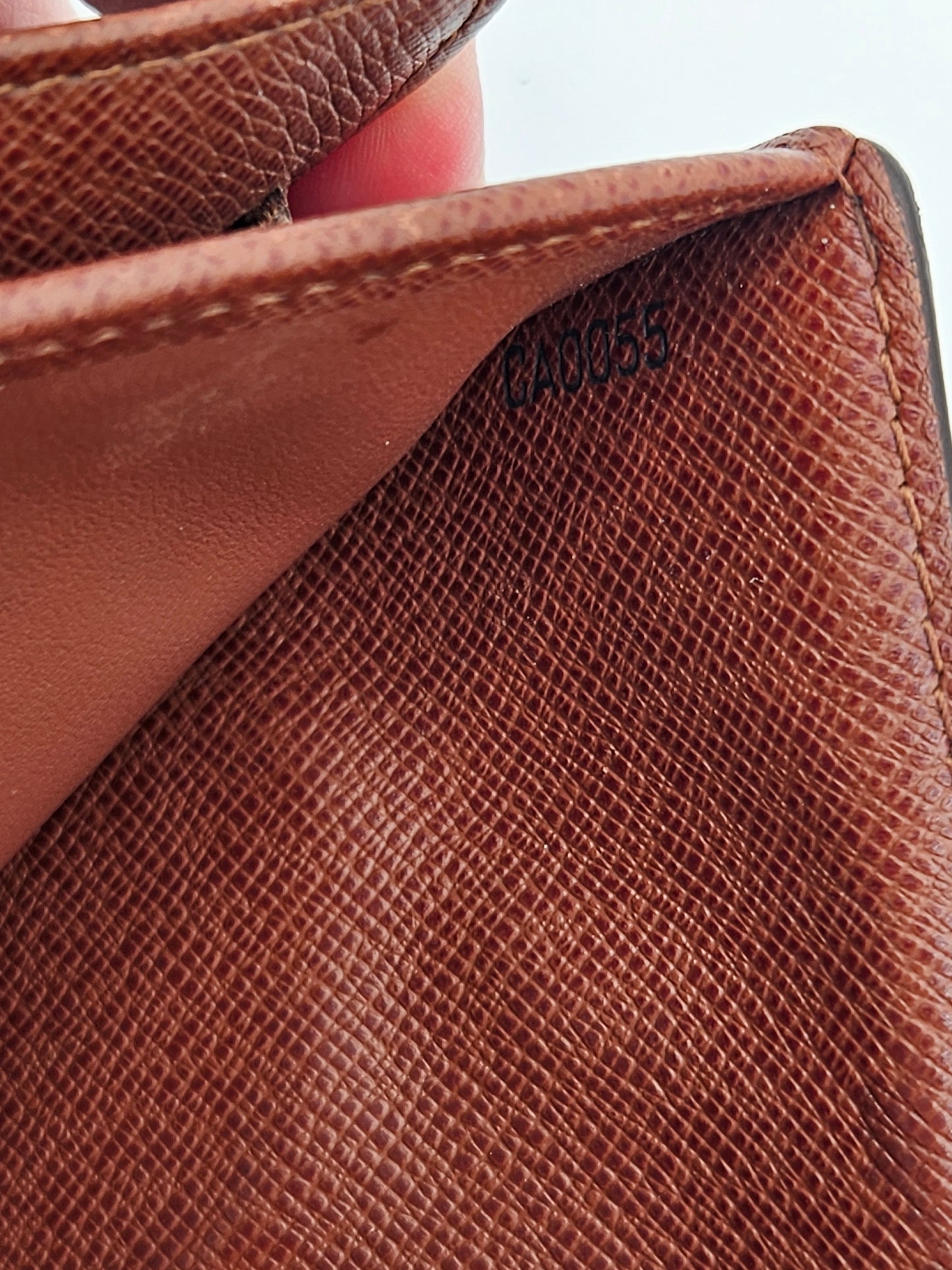 Close-up of a brown leather wallet with visible stitching