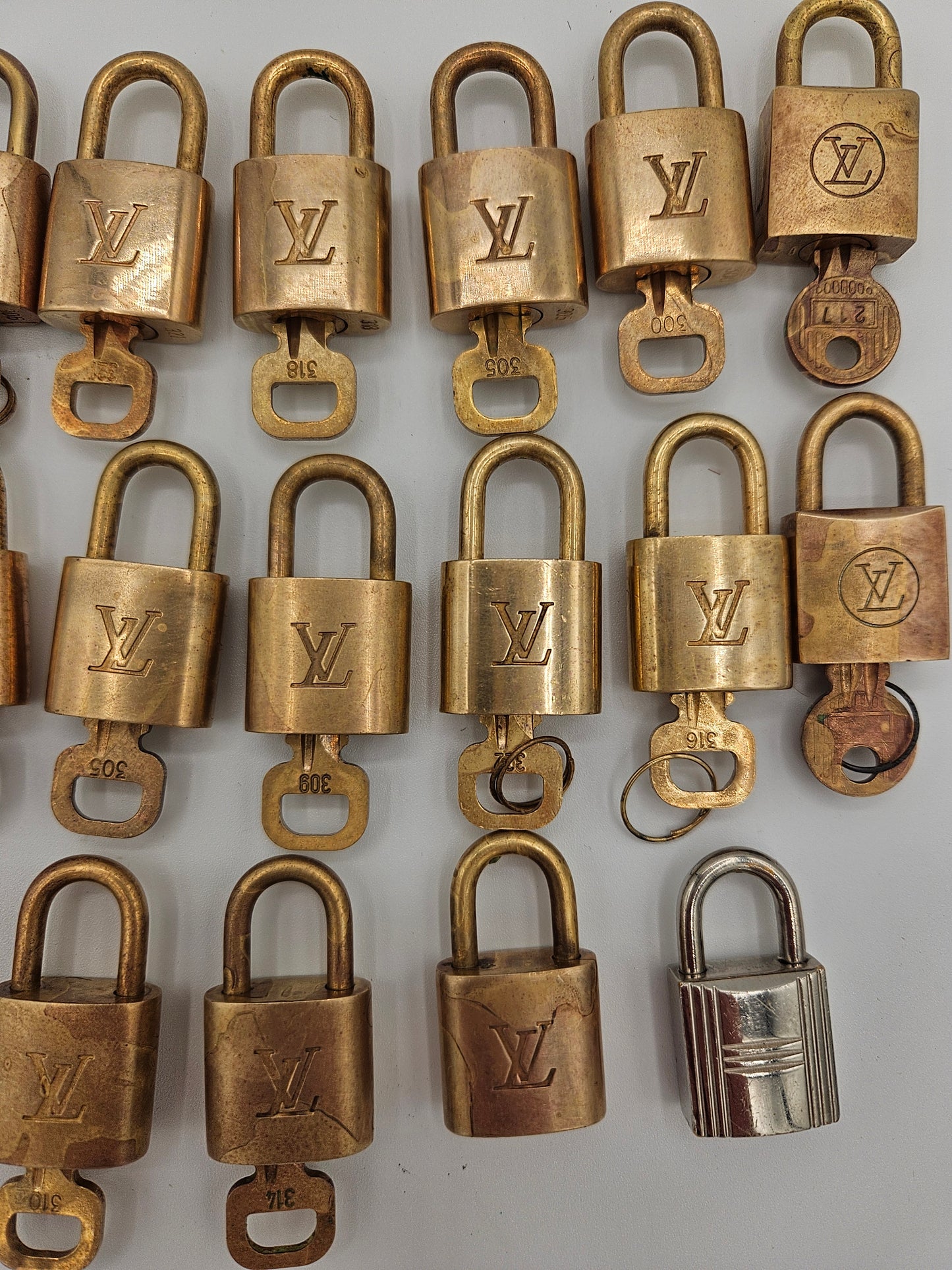 Collection of brass locks with a visible brand logo on a light gray background