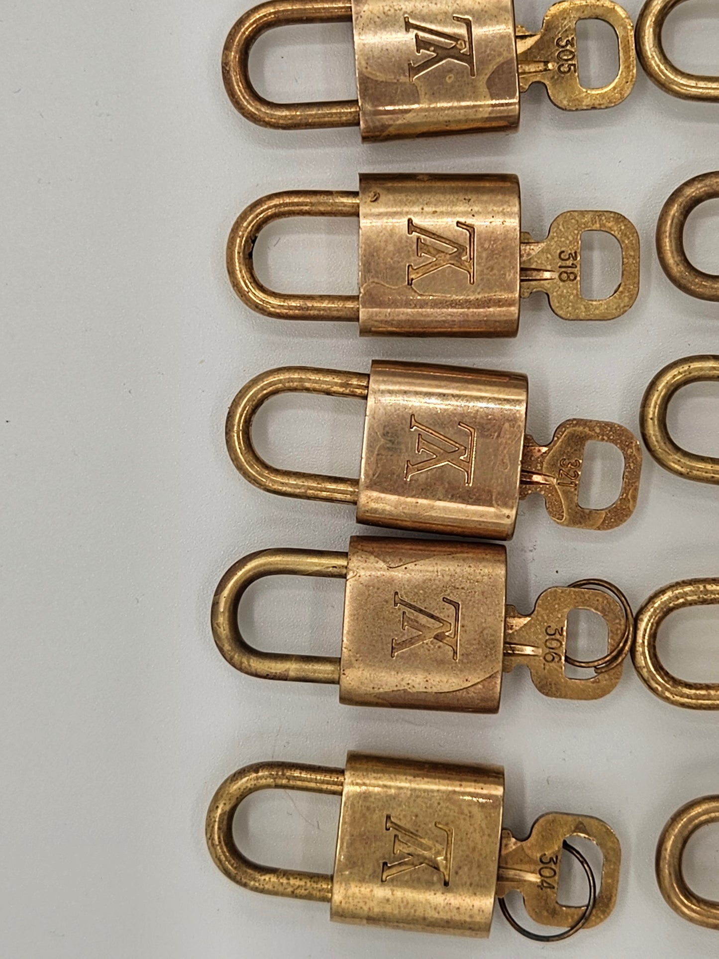 Row of brass locks with a visible brand logo on a white background