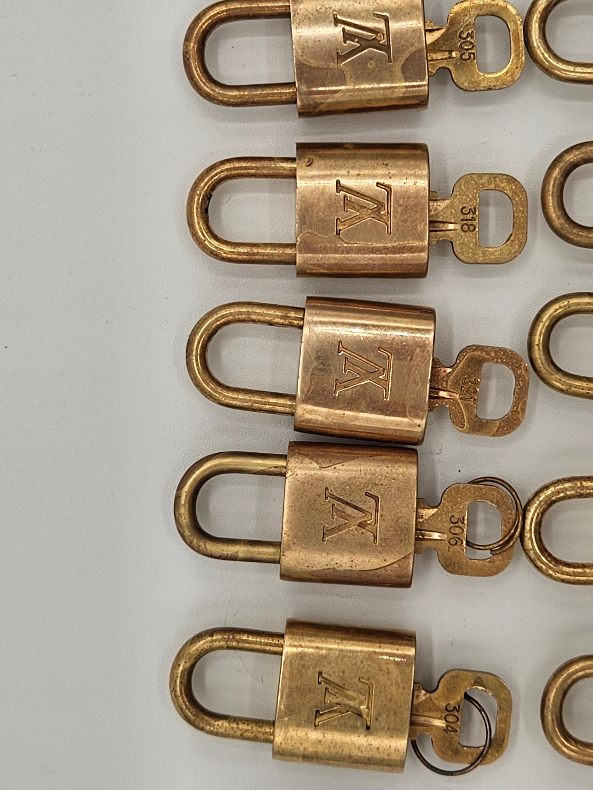 Row of brass locks with a visible brand logo on a white background