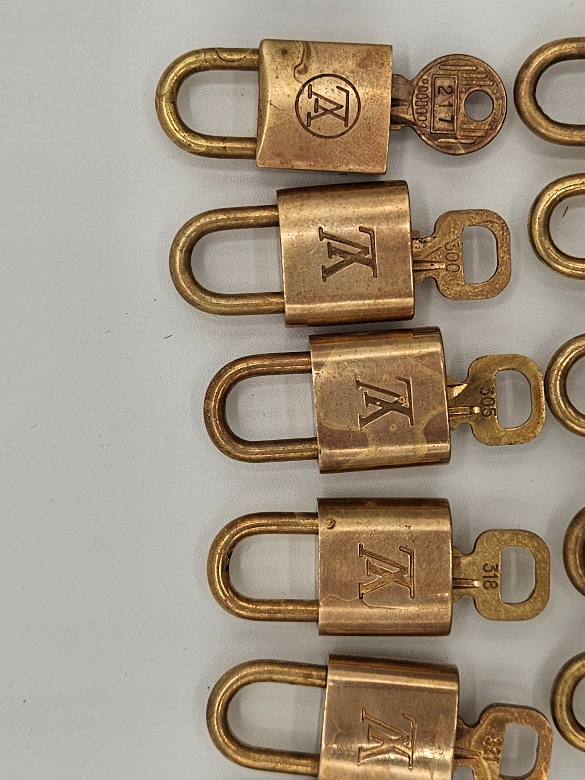 Row of brass locks with 'K' logo on a white background