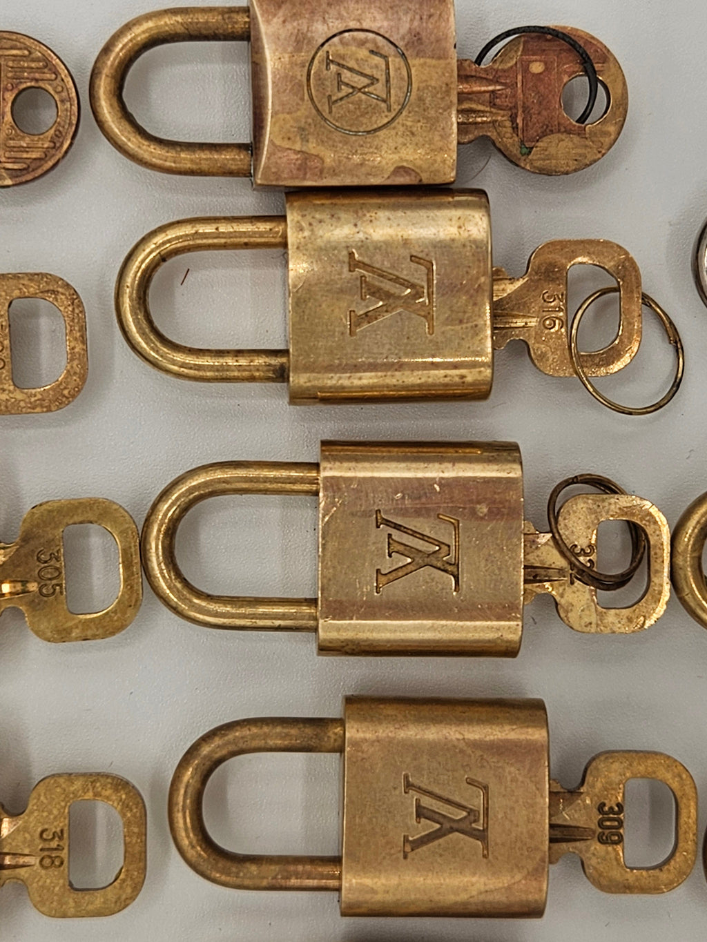 Collection of brass locks with 'TK' logo on a white background