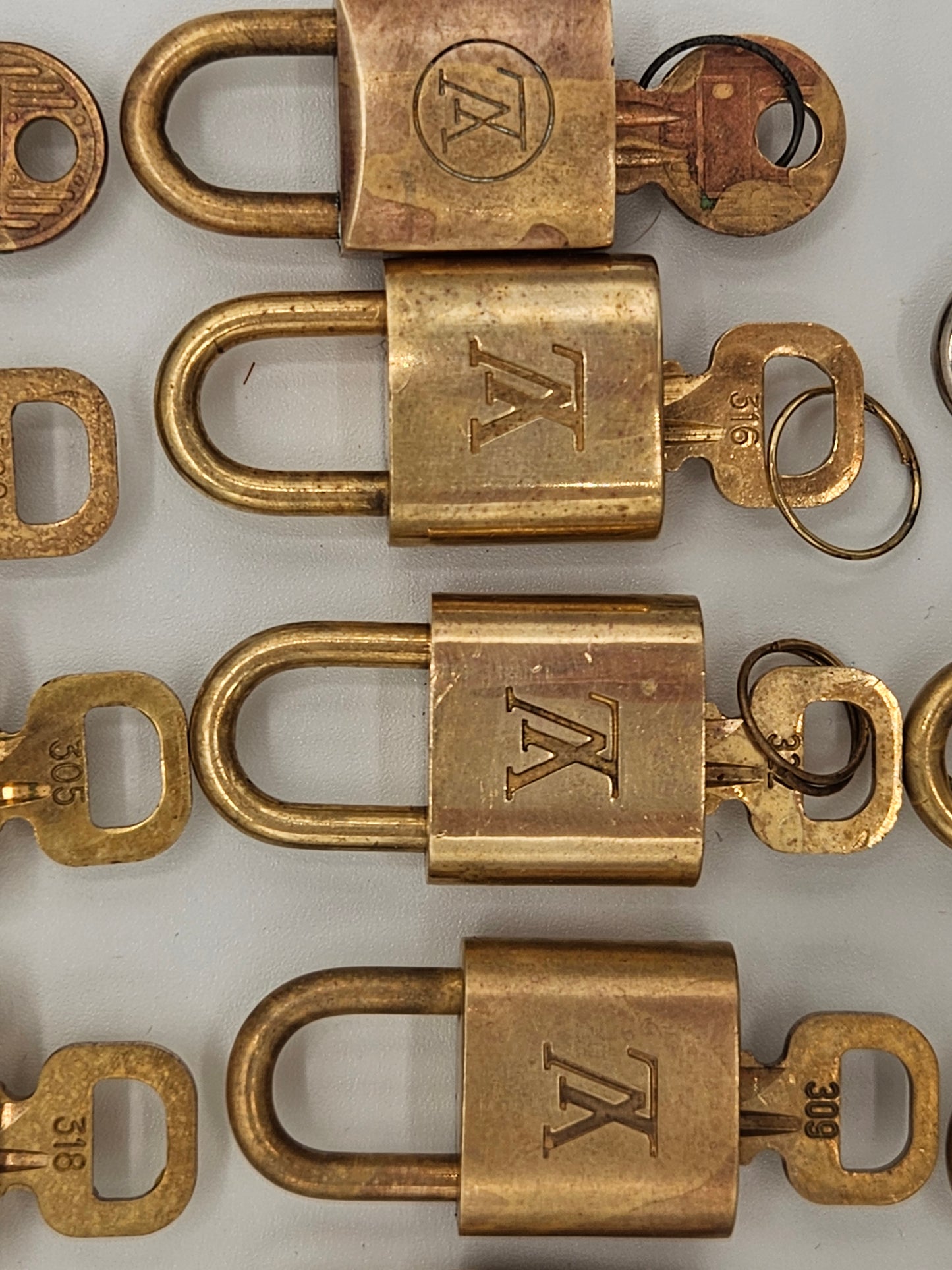 Collection of brass locks with 'TK' logo on a white background
