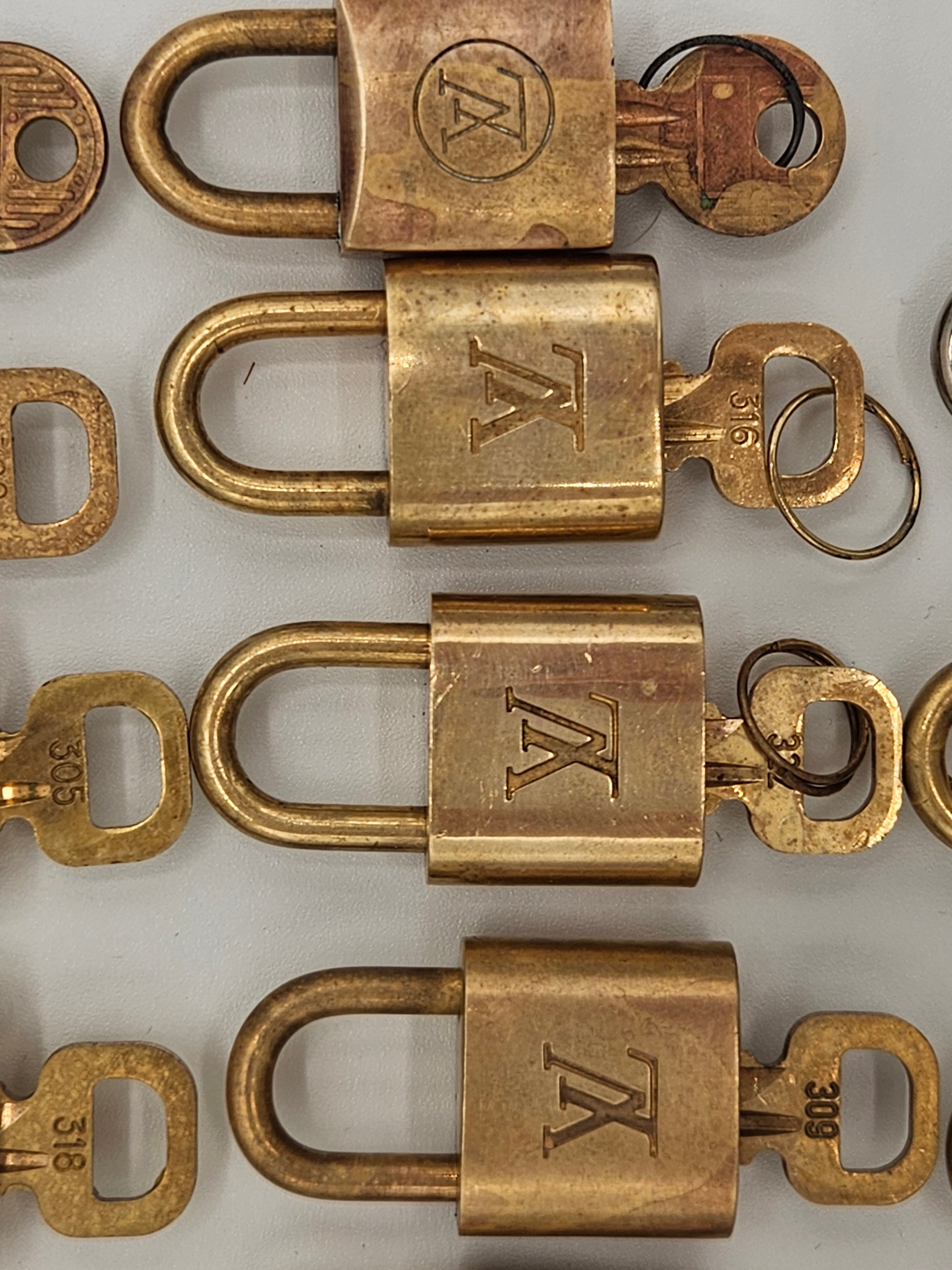 Collection of brass locks with 'TK' logo on a white background