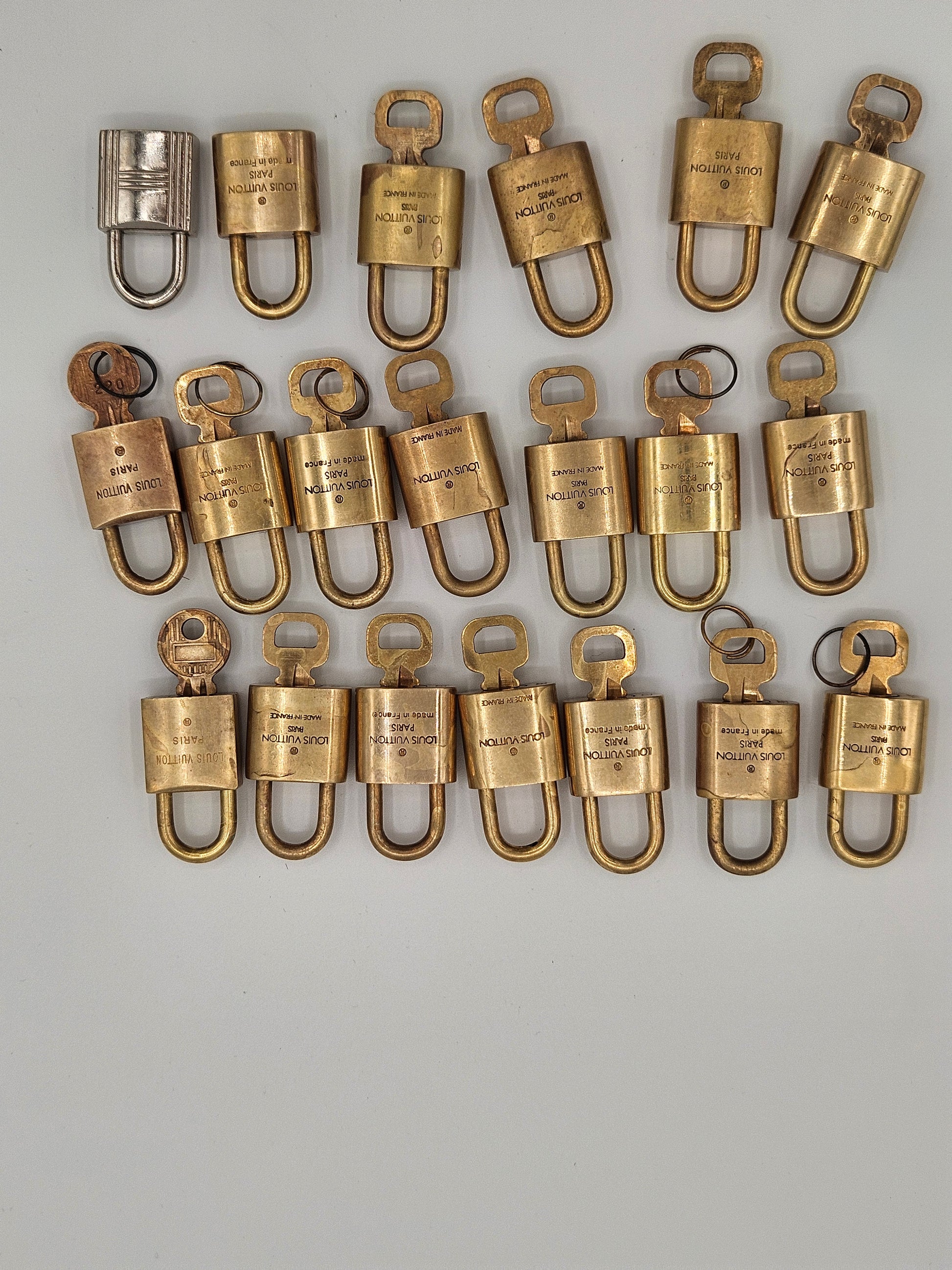 Collection of brass padlocks on a gray background