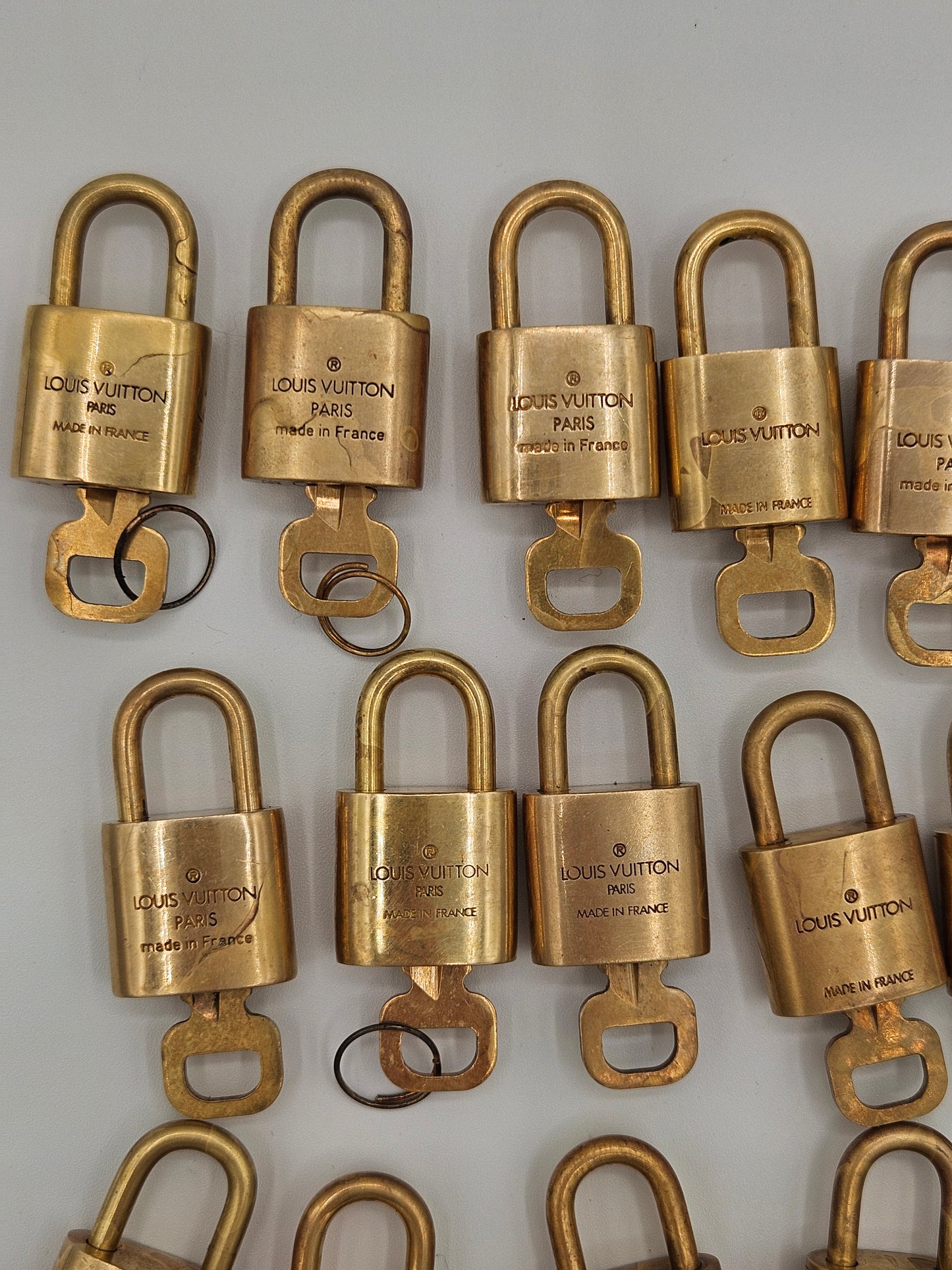 Multiple gold locks arranged on a light gray background