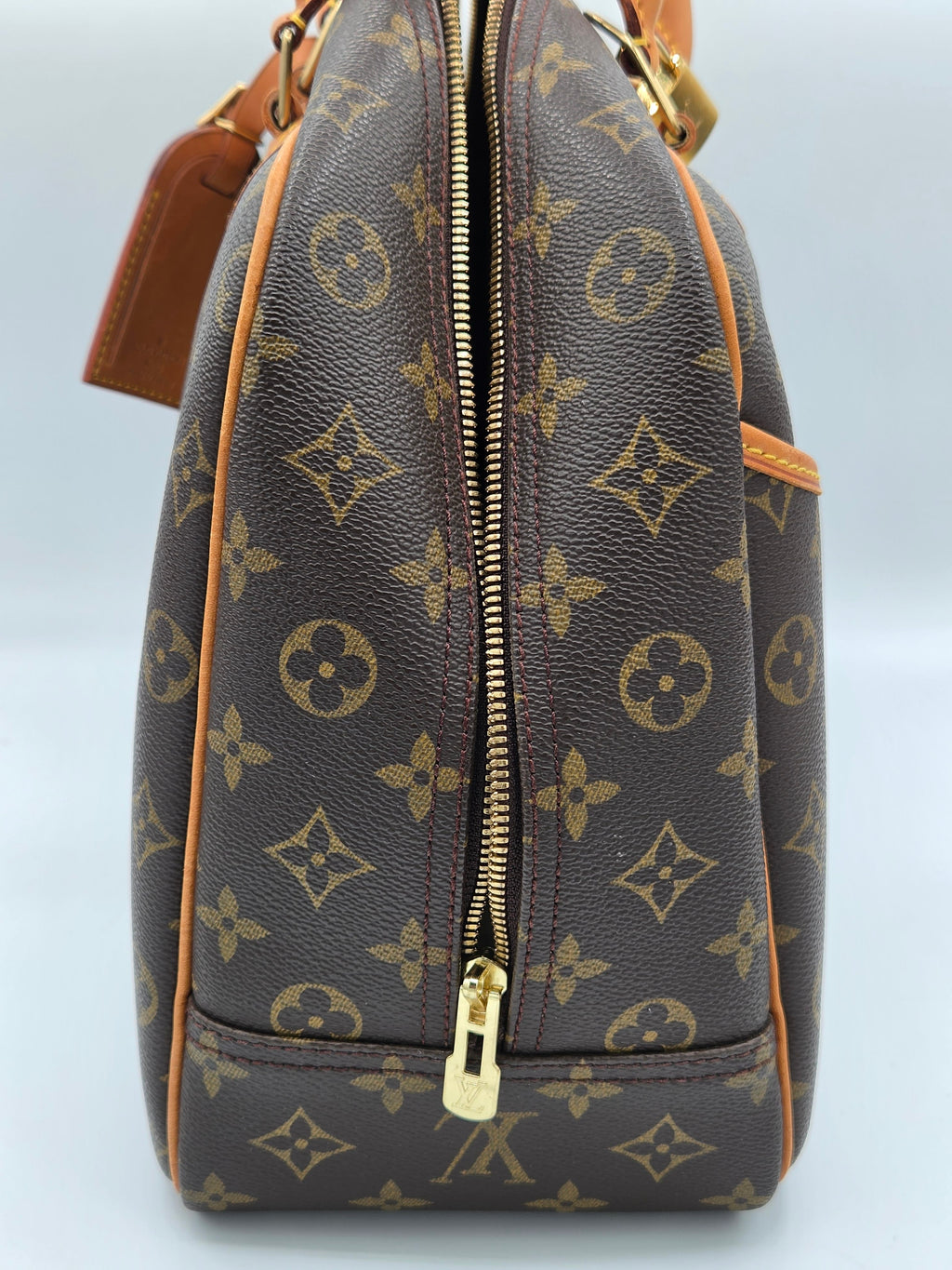 Louis Vuitton monogram handbag on a light gray background