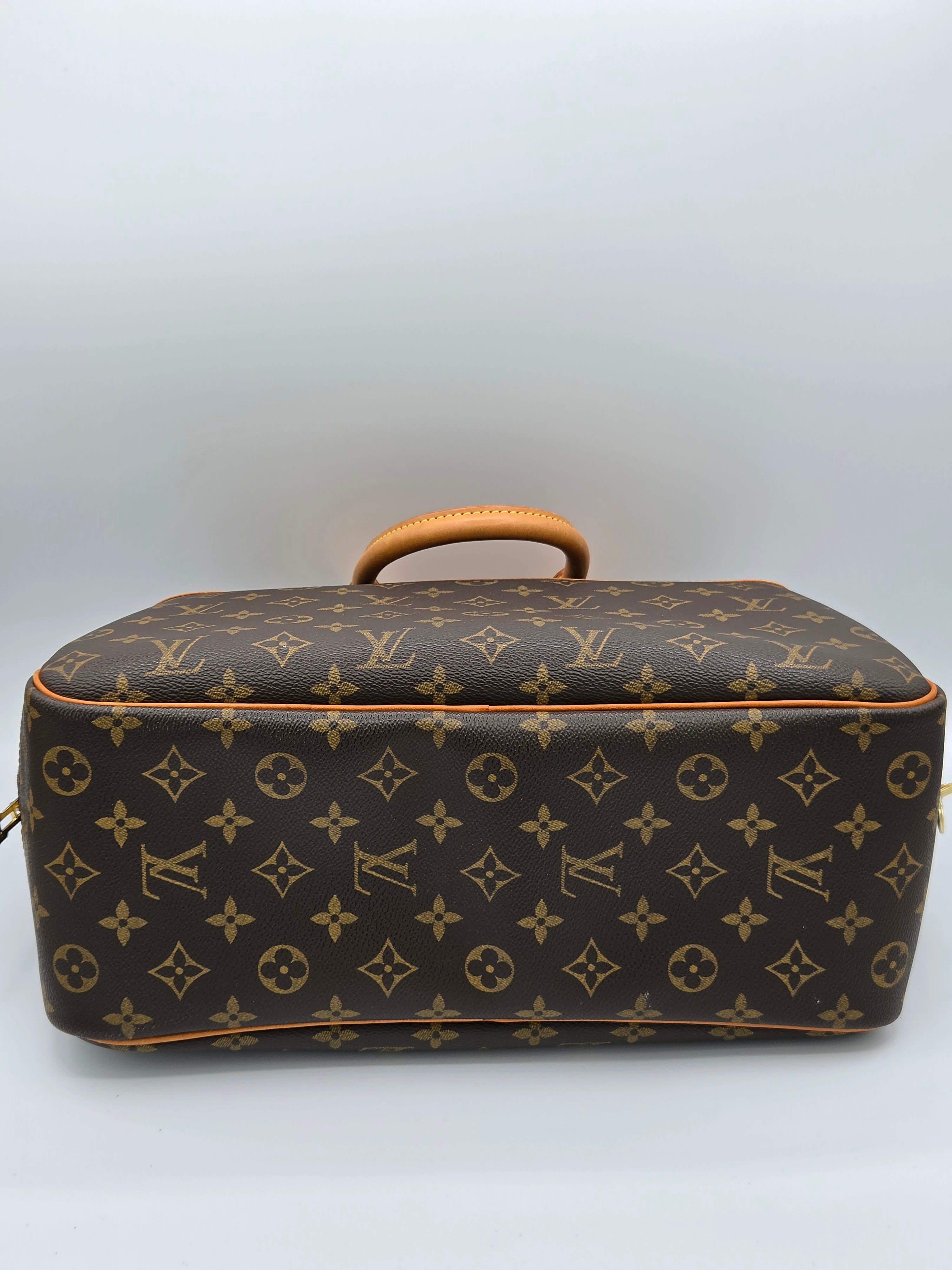 Louis Vuitton monogram handbag on a light gray background