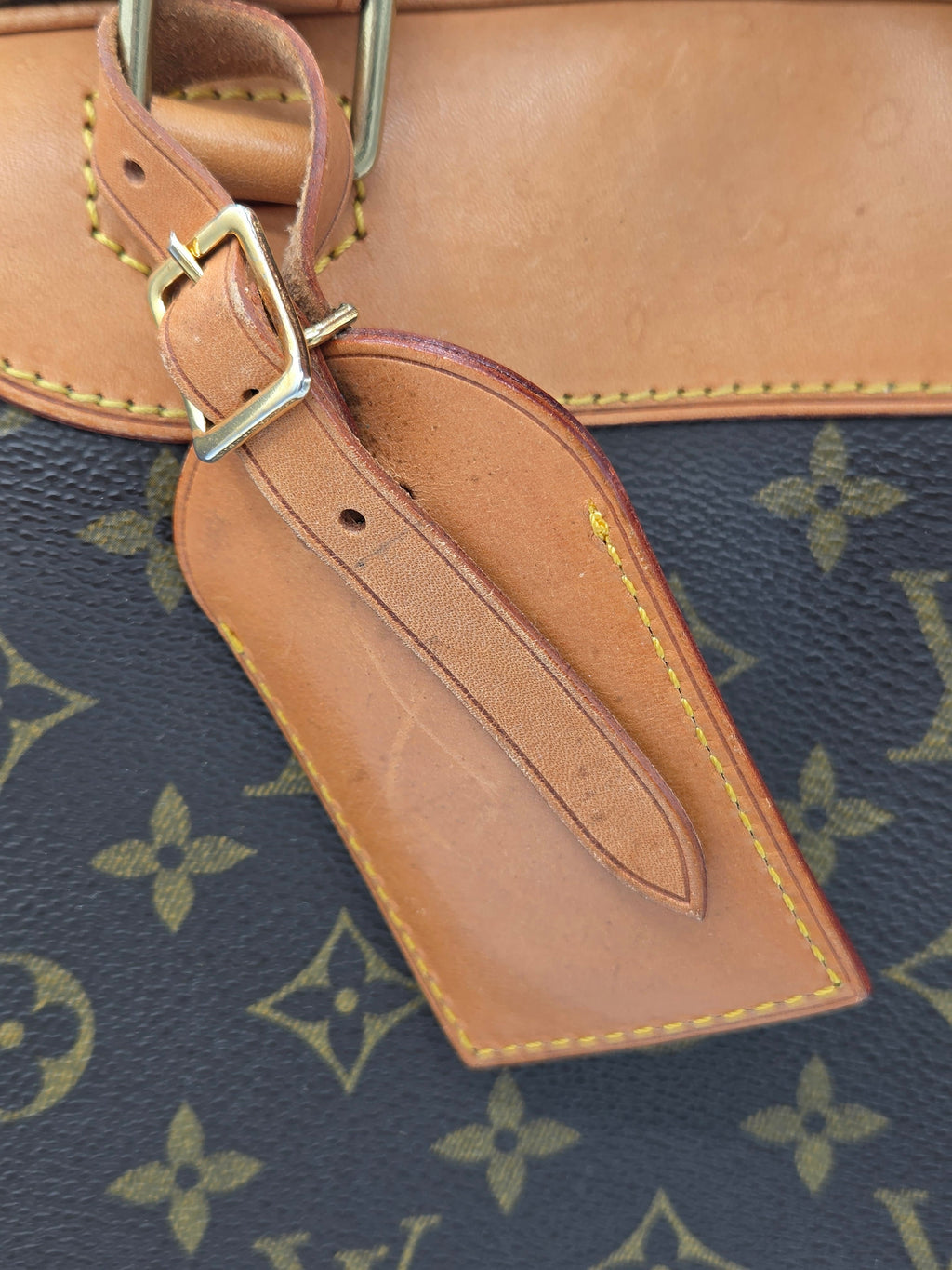 Close-up of a brown leather strap on a patterned background