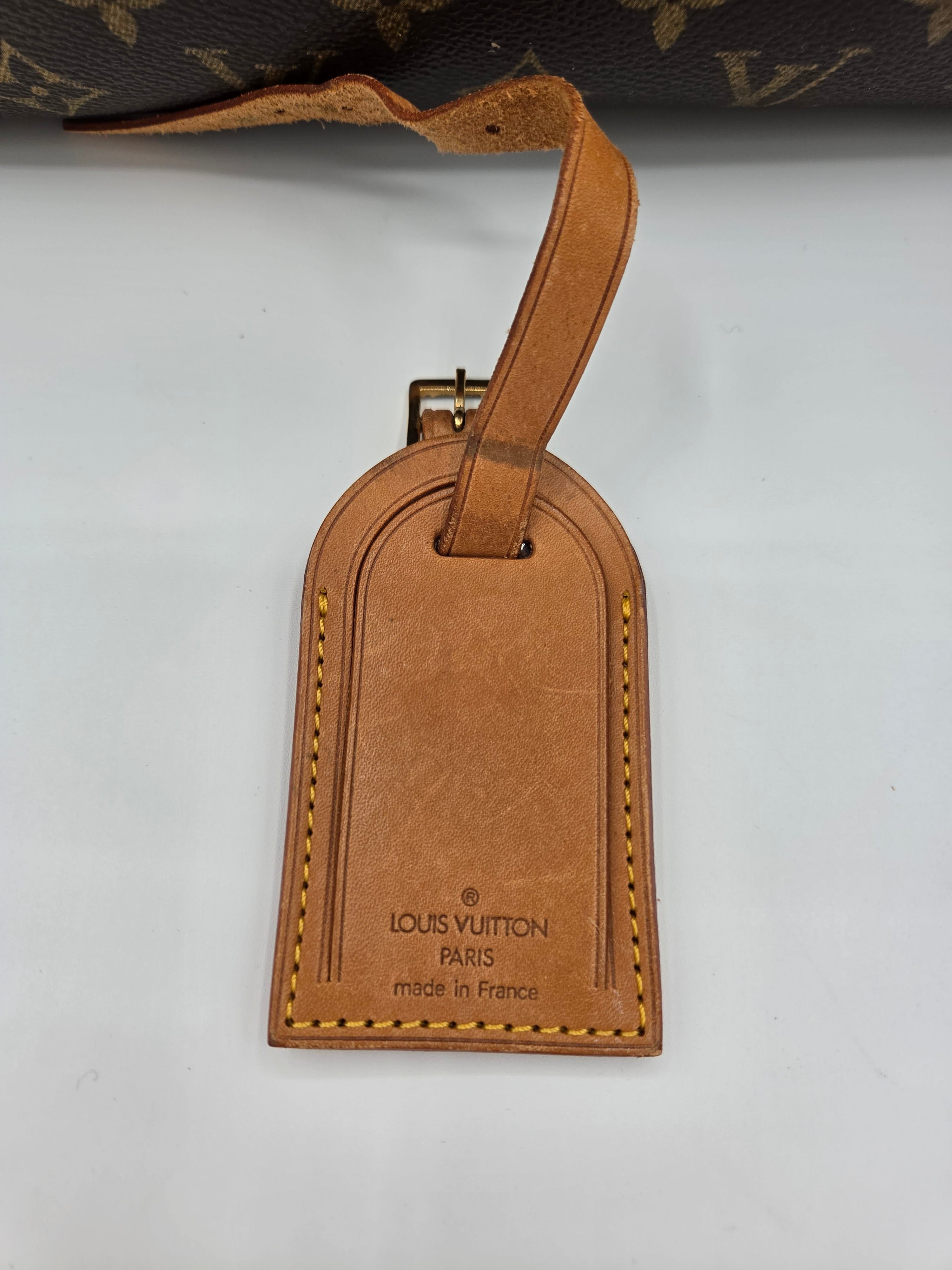 Brown Louis Vuitton luggage tag on a white background