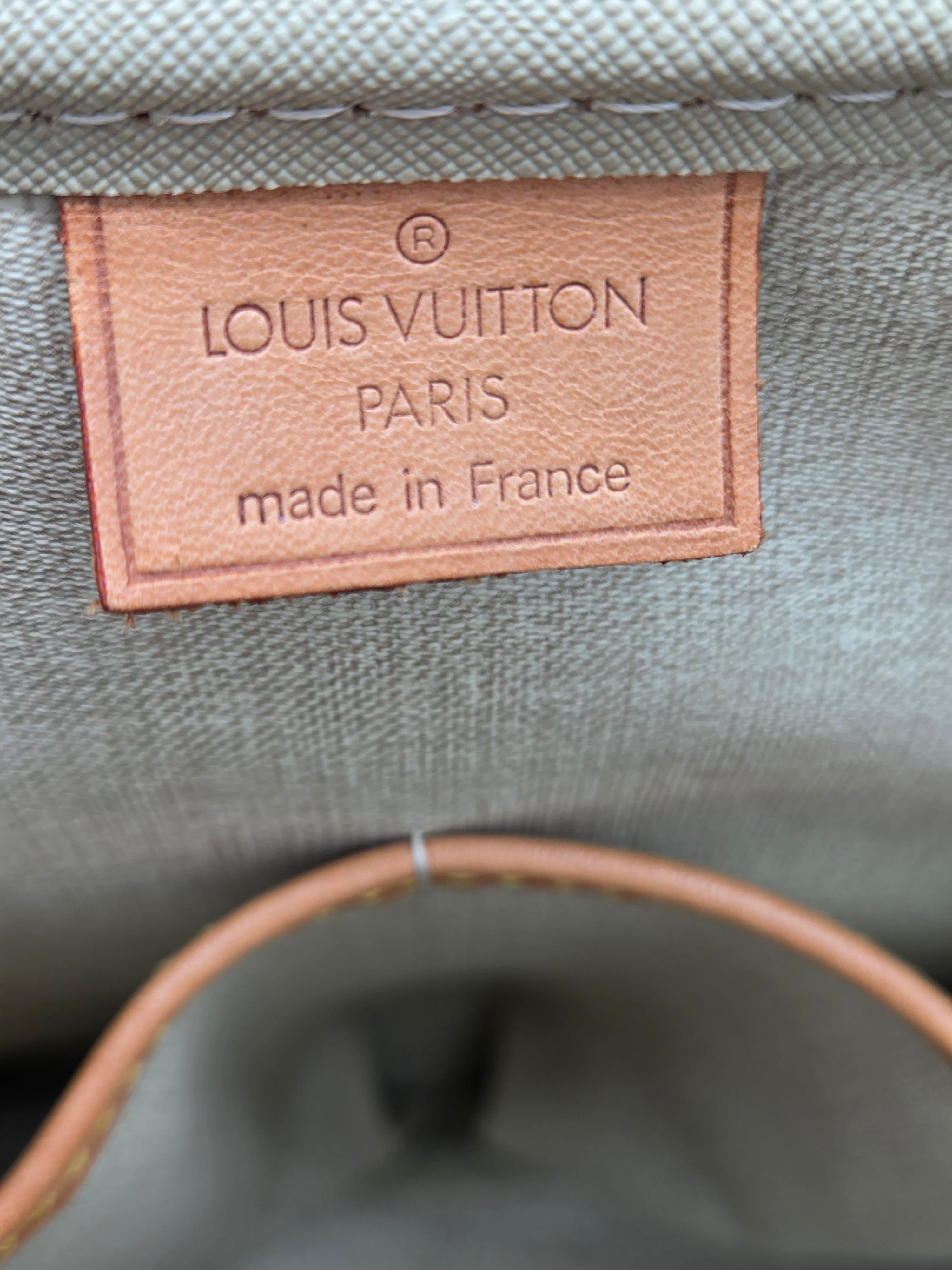 Louis Vuitton label on a gray textured surface