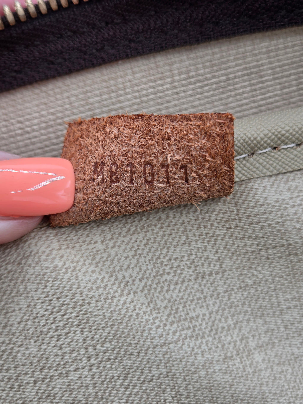 Close-up of a brown fabric tag on a gray fabric background