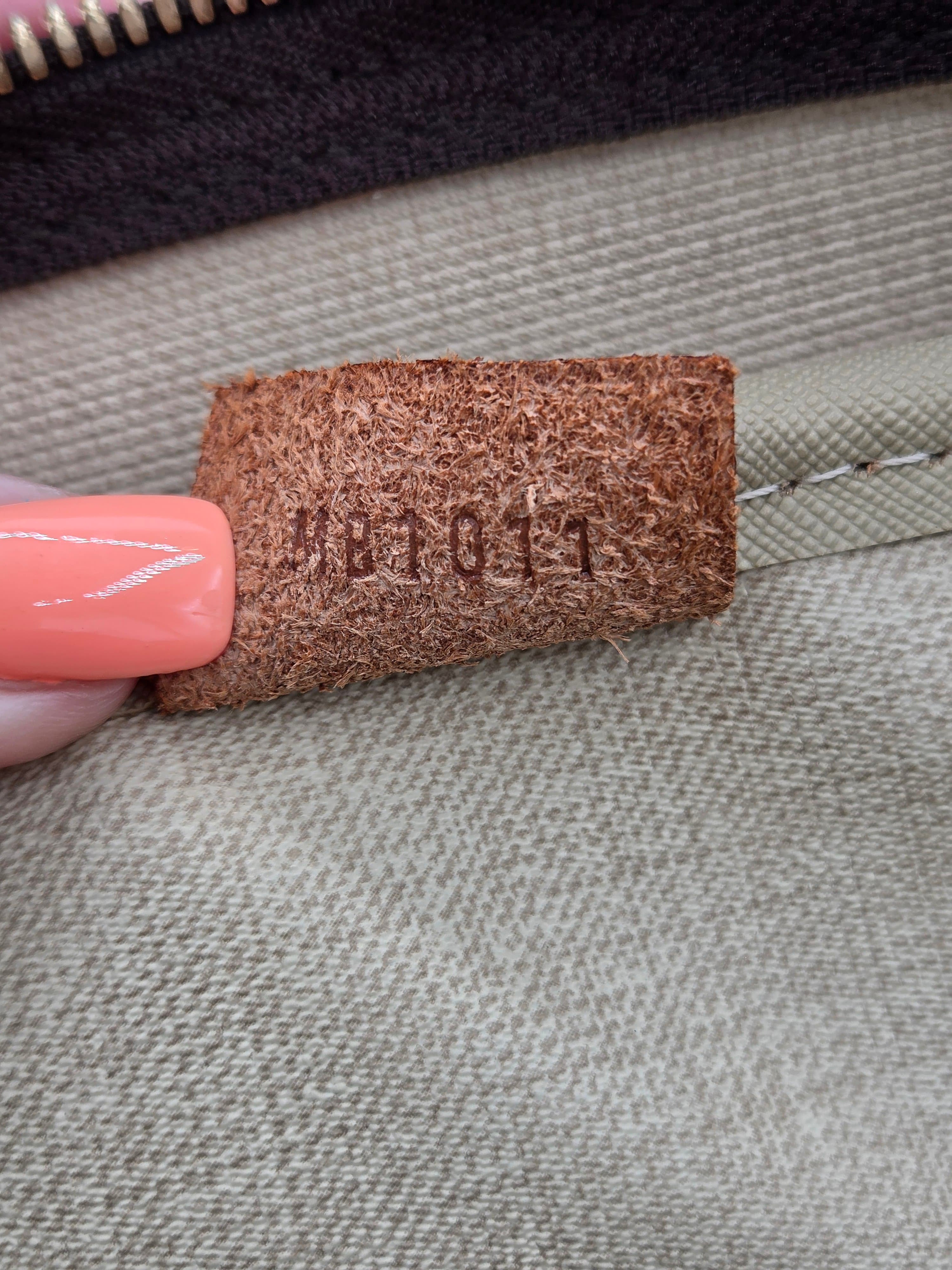 Close-up of a brown fabric tag on a gray fabric background