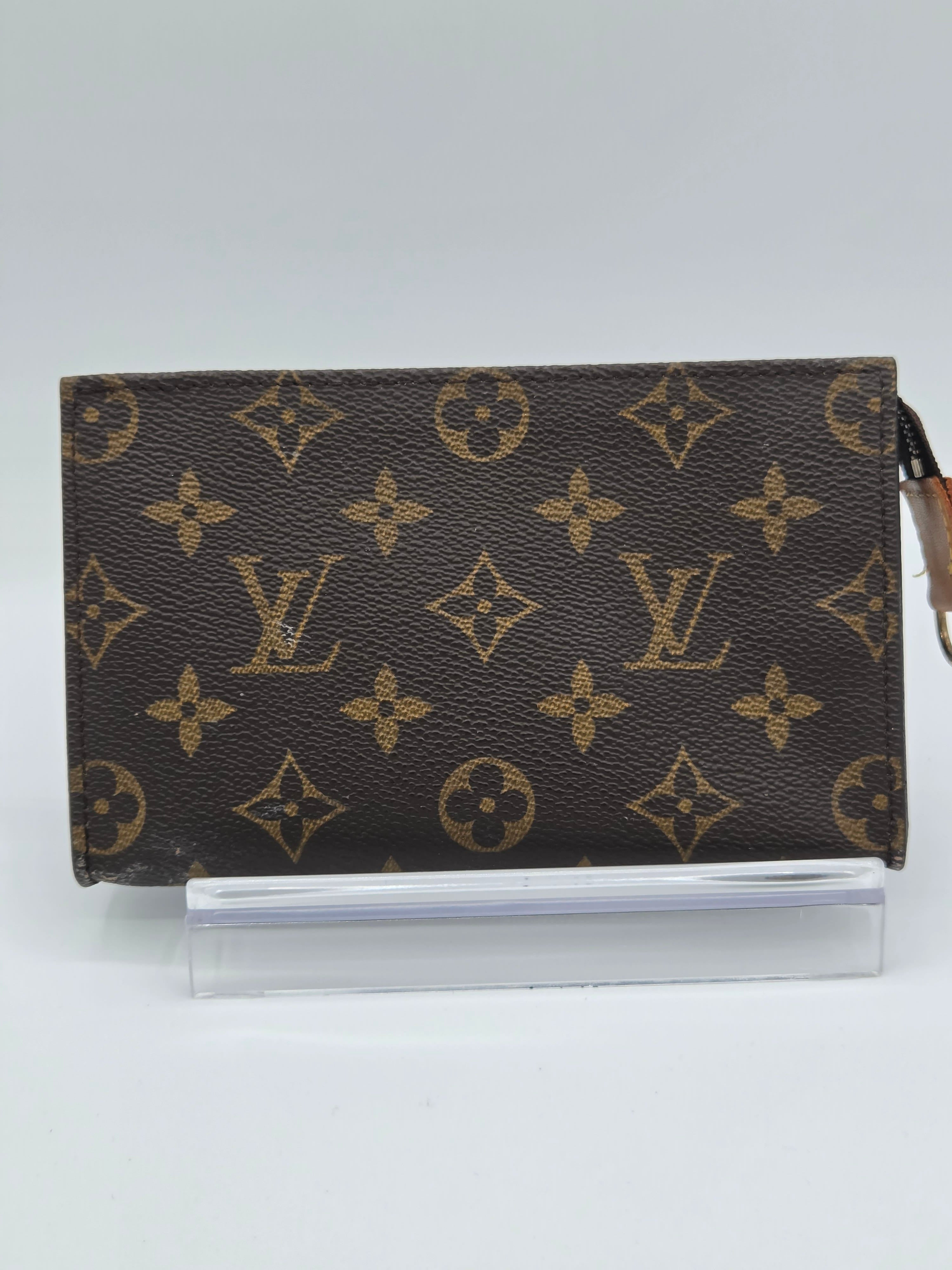Louis Vuitton monogram patterned notebook on a white background