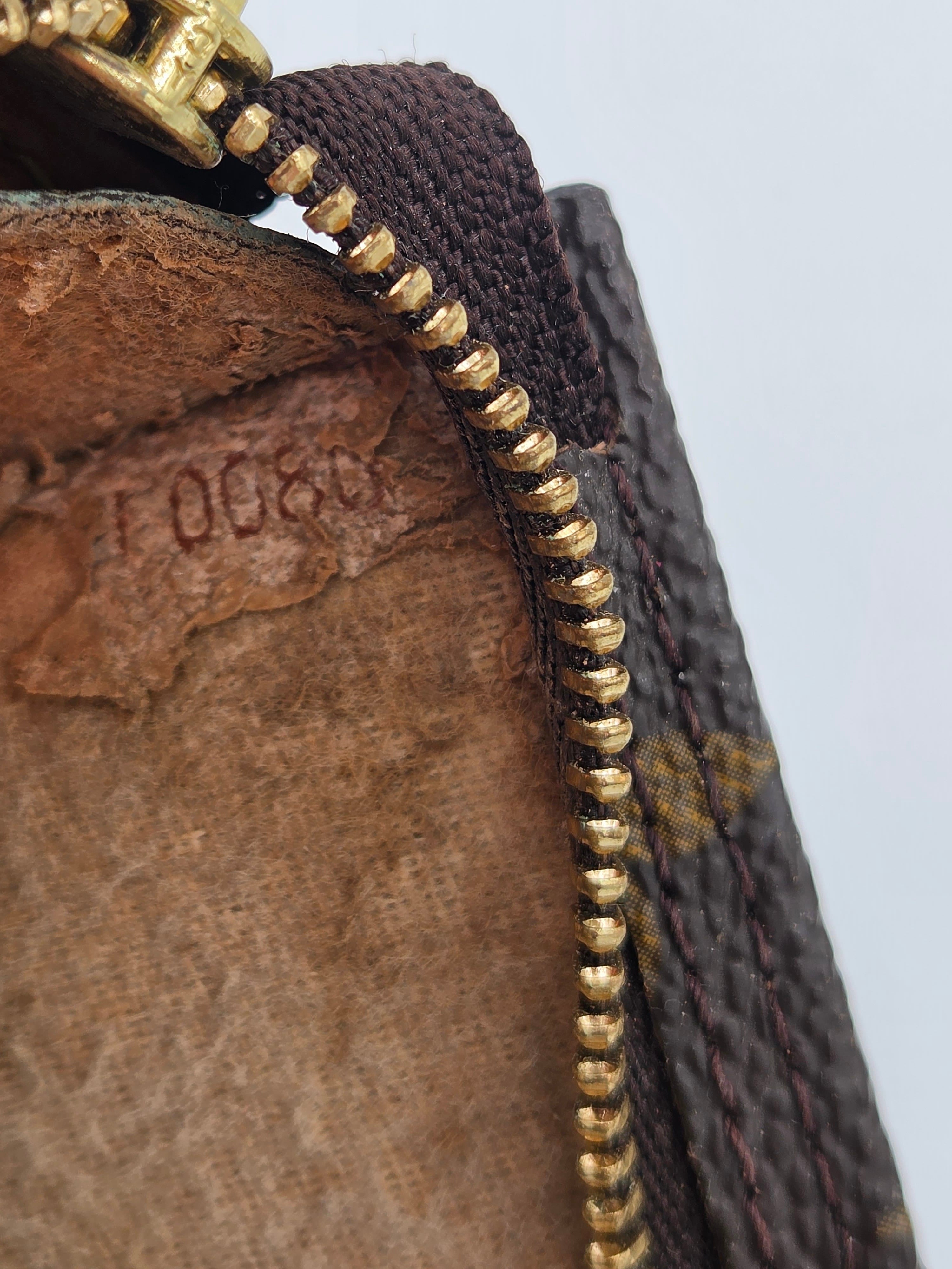 Close-up of a textured surface with gold zipper and brown fabric