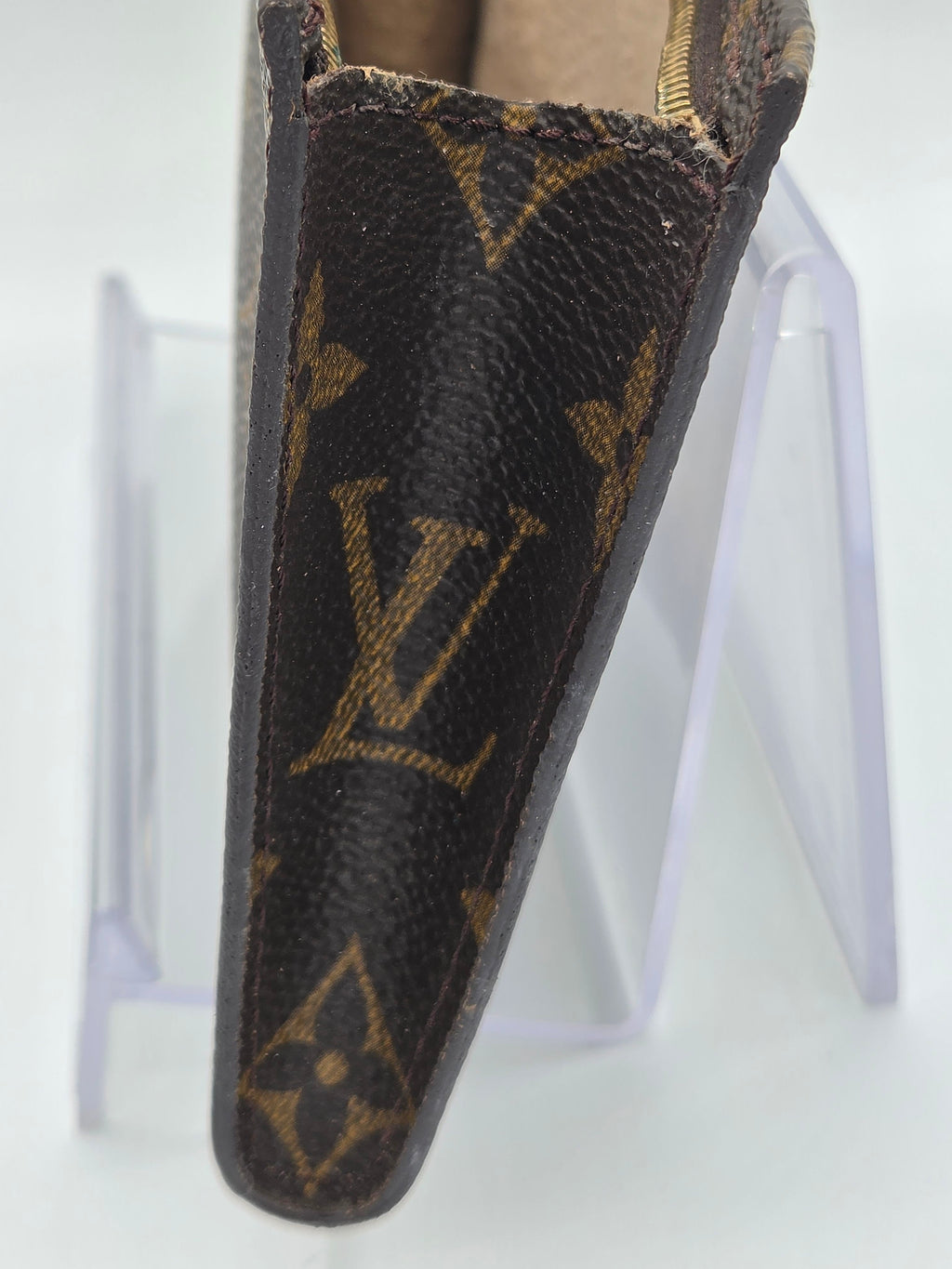 Louis Vuitton wallet with monogram pattern on a white background