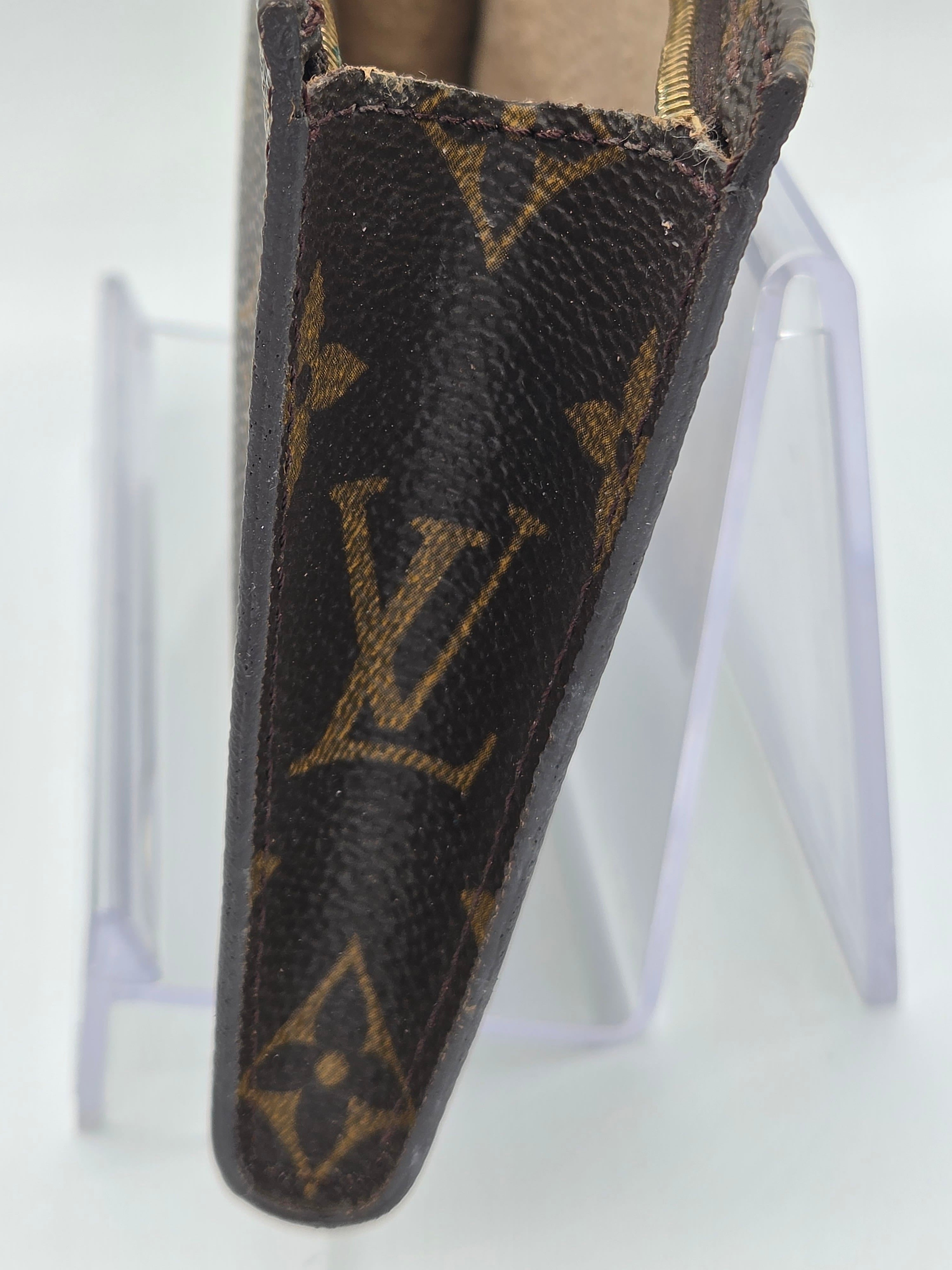 Louis Vuitton wallet with monogram pattern on a white background