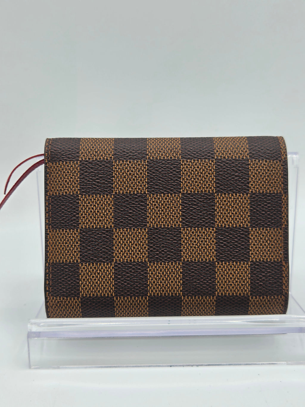 Checkered patterned bag with a strap on a white background