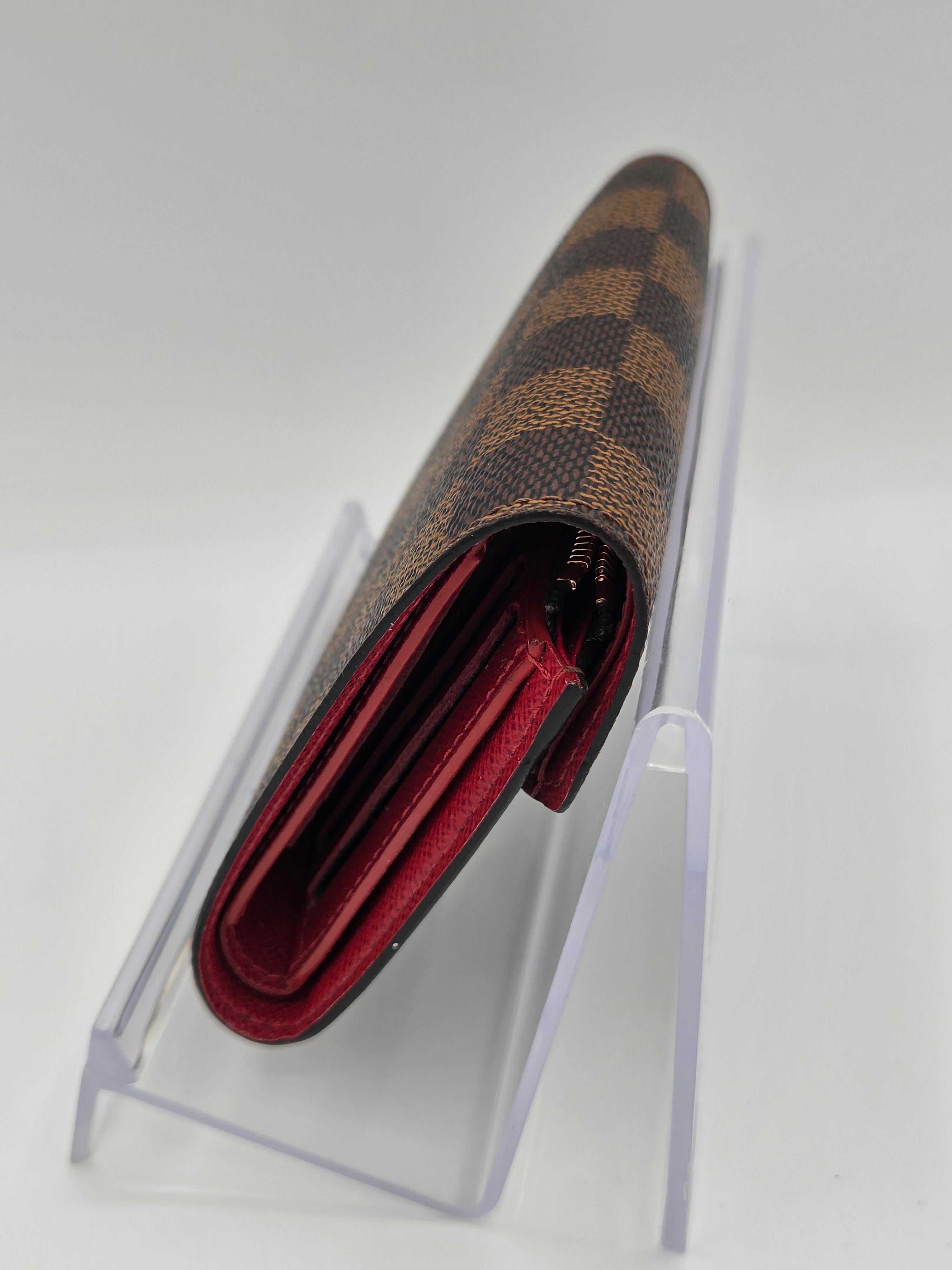 Designer wallet with brown and gold pattern on a white background