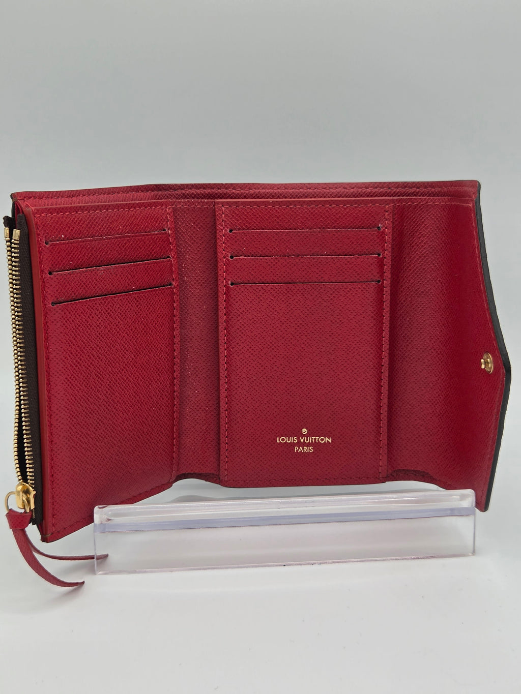 Red wallet with gold accents on a white background