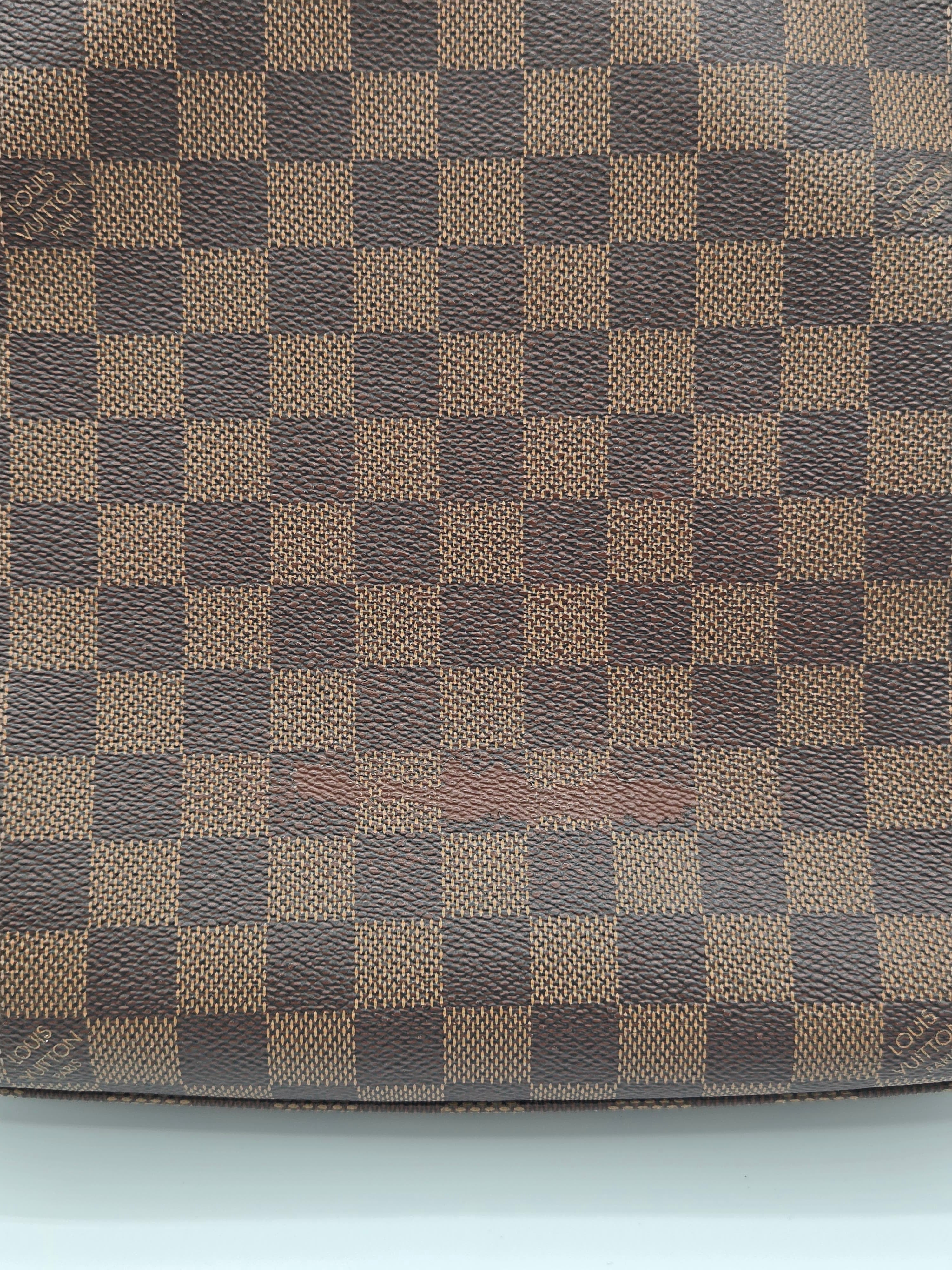 Checkered pattern fabric with brown and beige squares on a plain background