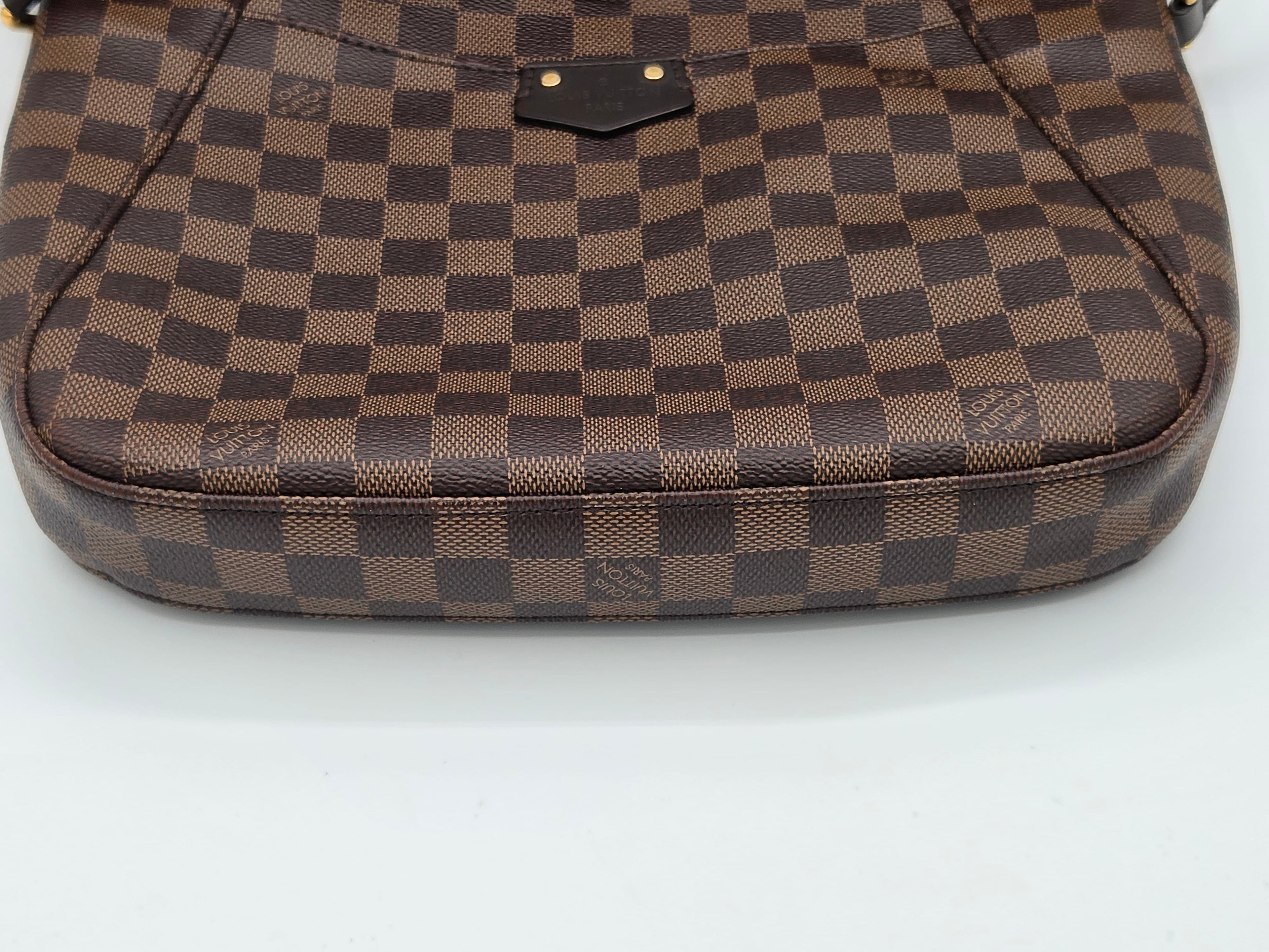 Brown checkered handbag on a white background