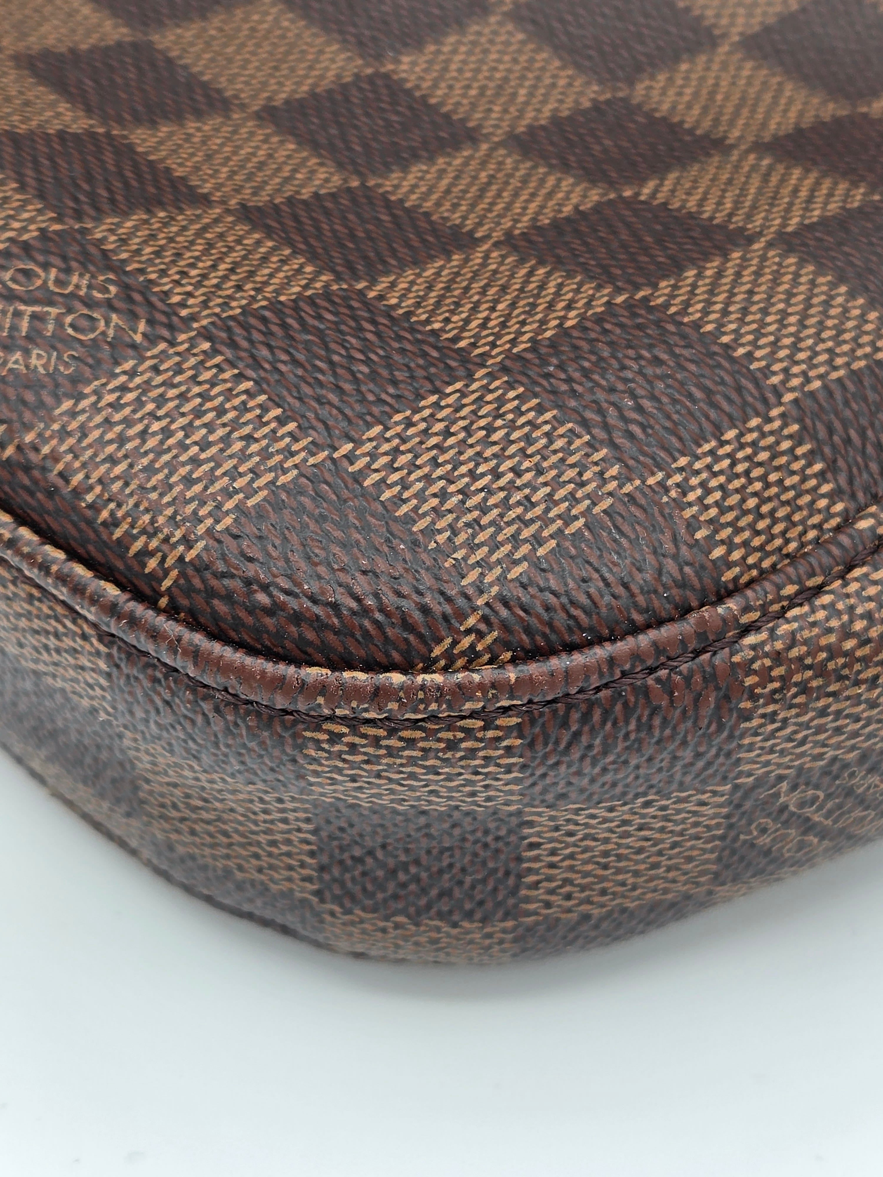 Close-up of a brown checkered fabric with visible brand logo on a white background