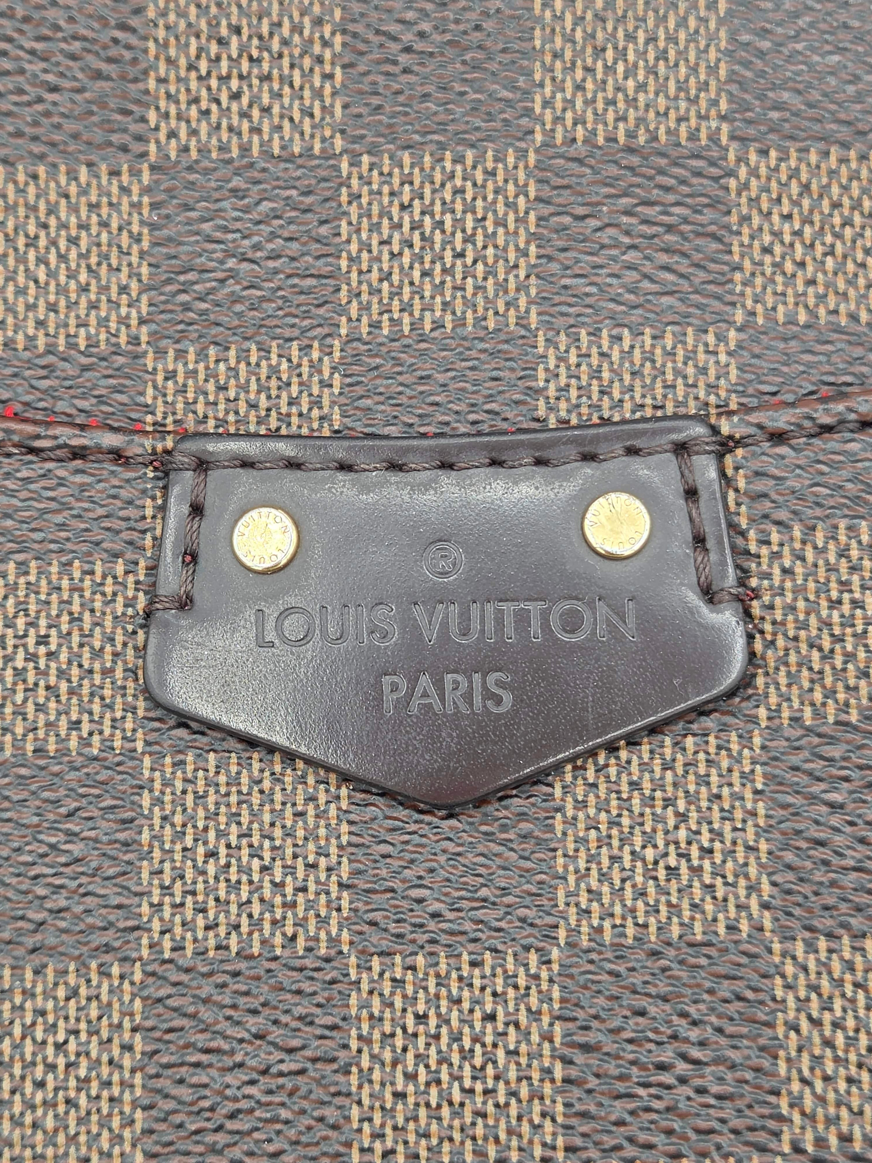 Louis Vuitton tag on a textured fabric background