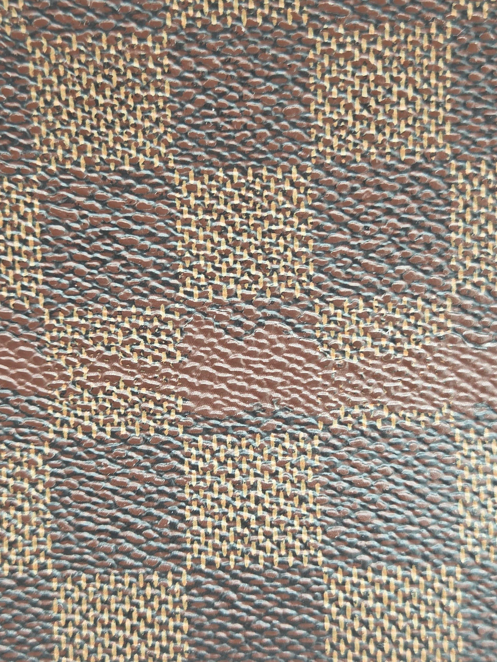 Close-up of a woven fabric with brown and beige pattern