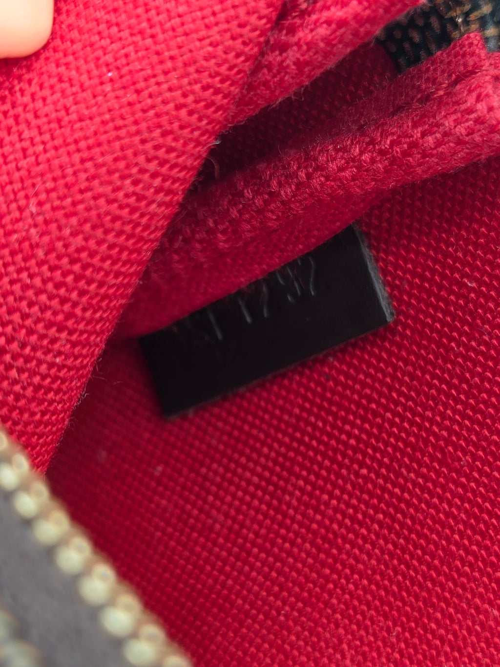 Close-up of a red fabric surface with a black label.
