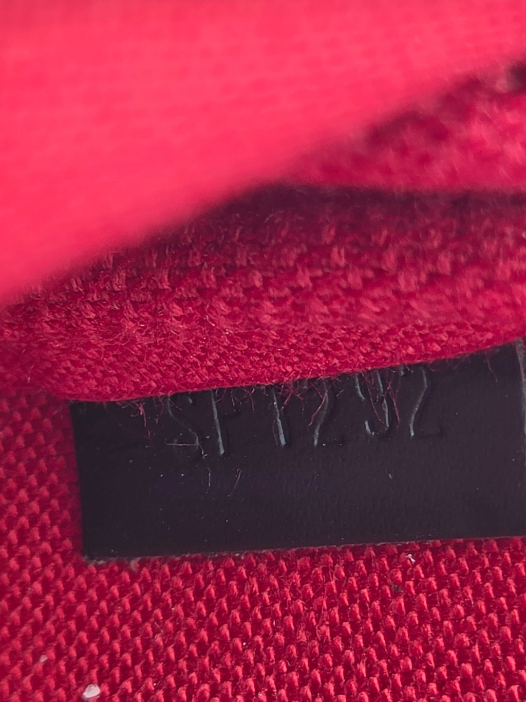 Close-up of red fabric with a black label