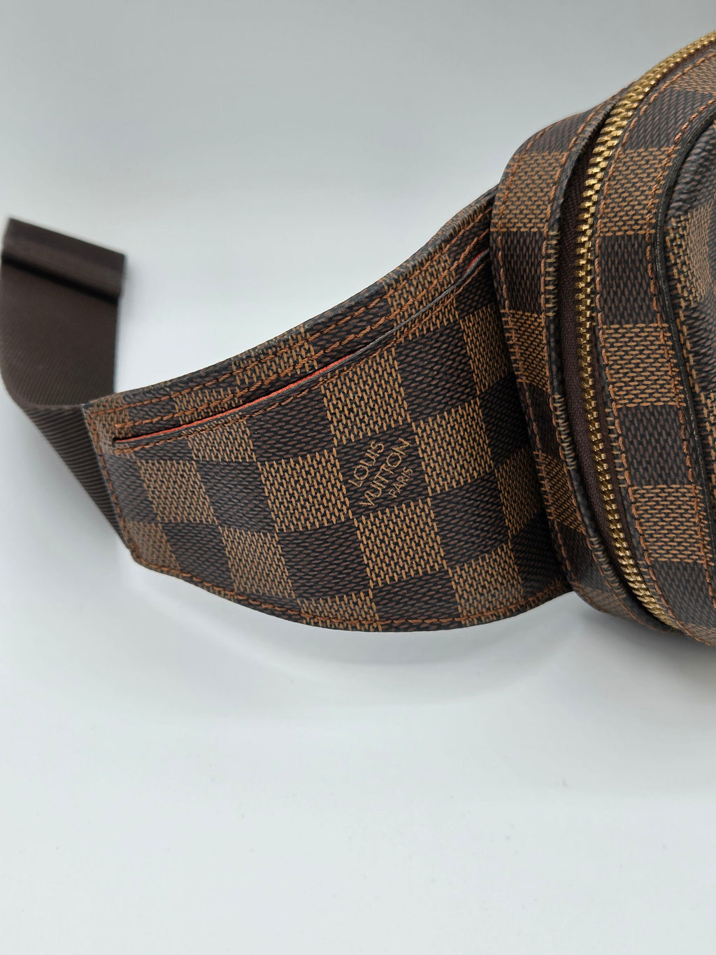 Brown checkered bag with visible brand logo on a light gray background