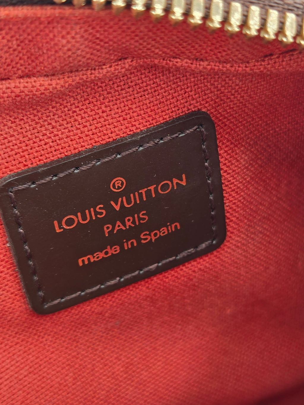 Louis Vuitton label on a red fabric background