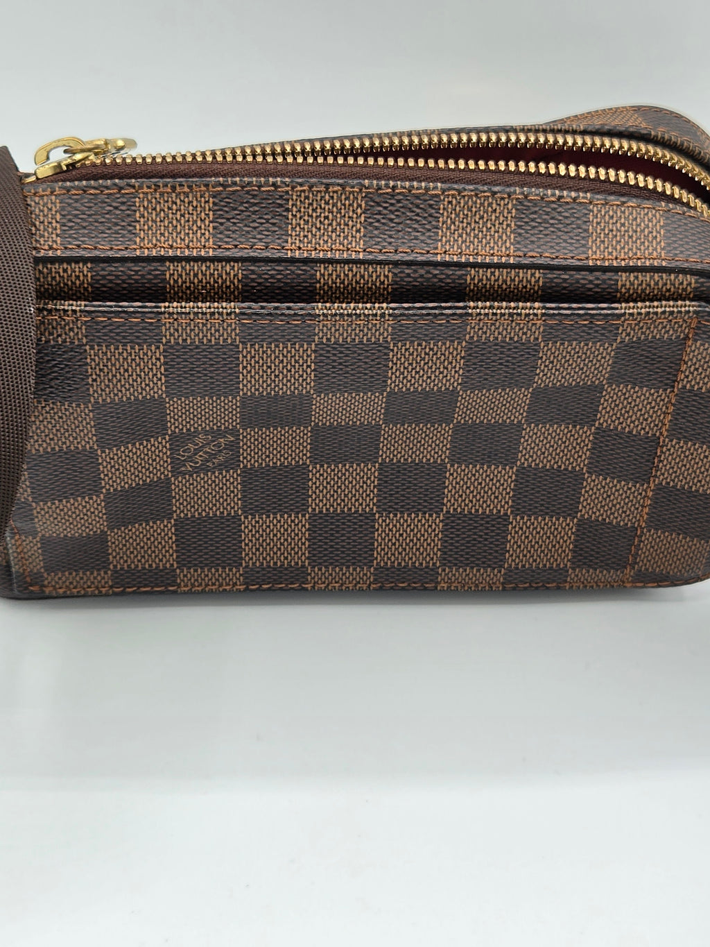 Brown checkered pouch with gold zipper on a light gray background